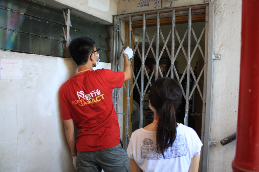 Volunteers carefully re-painting the iron gates