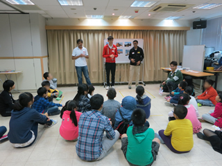 Volunteers greeting the children before the games start