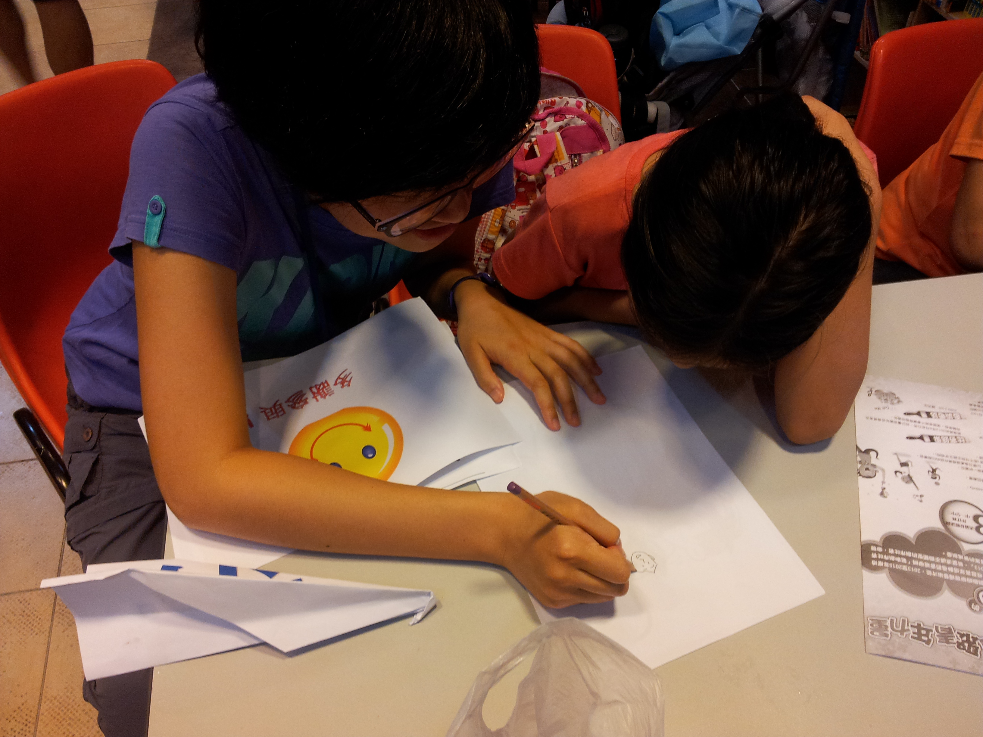 Happily drawing with the children