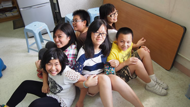 Volunteers and children playing team building game