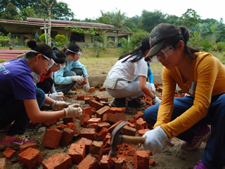 Breaking the bricks for the lower layer of patio floor