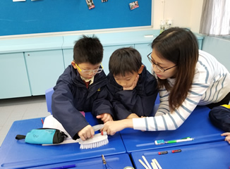 Volunteers teaching STEM workshops in the classrooms