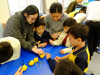 Students doing a Science experiment with the guidance from our volunteers