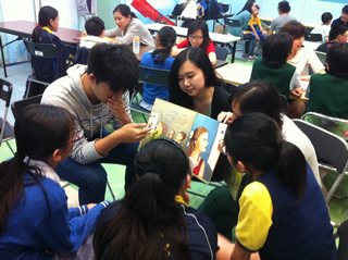 Volunteers reading story to the children