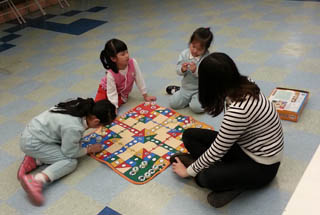 Volunteer playing games with the kids