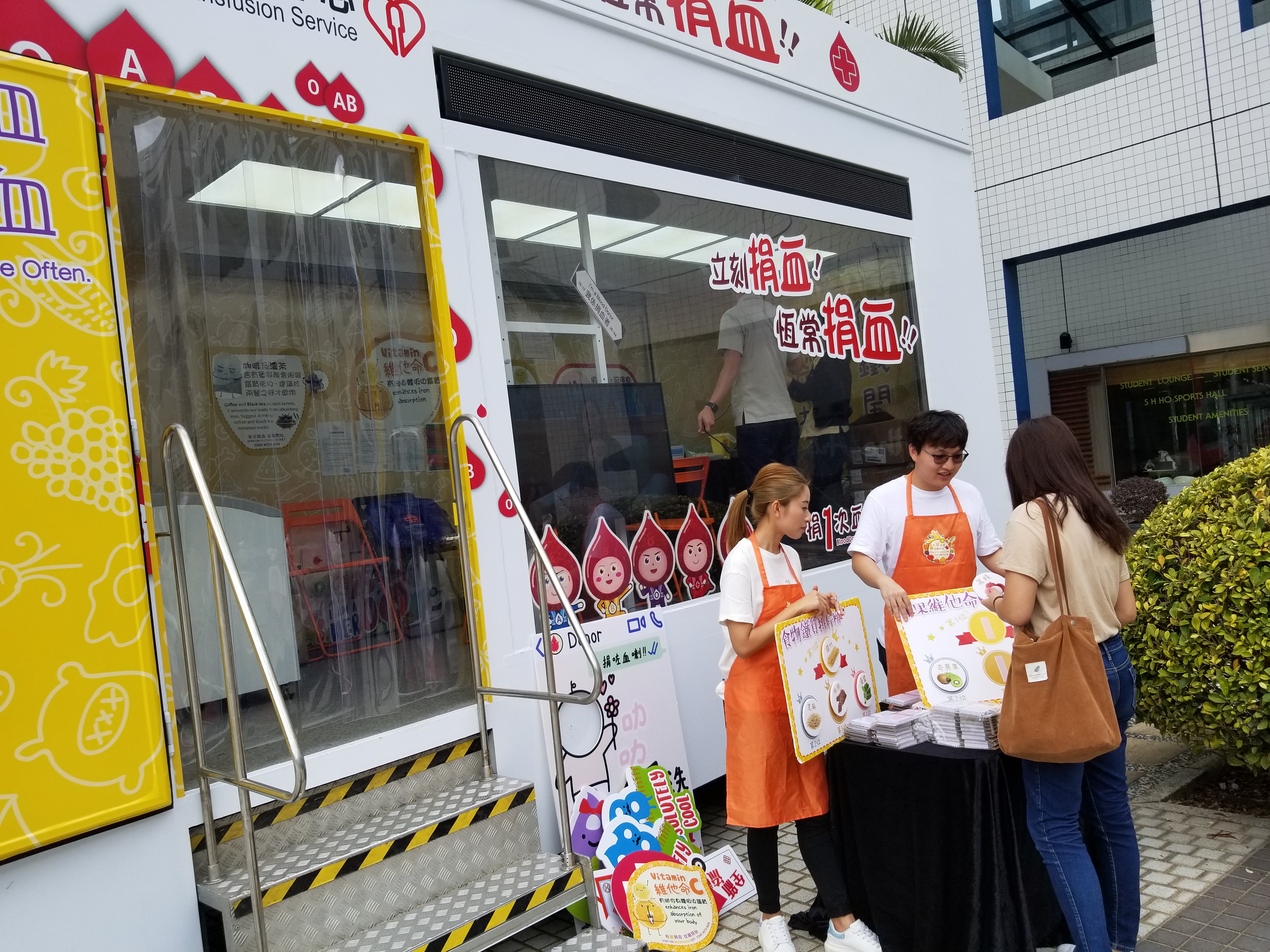 Volunteers hosting booth games to promote blood donation