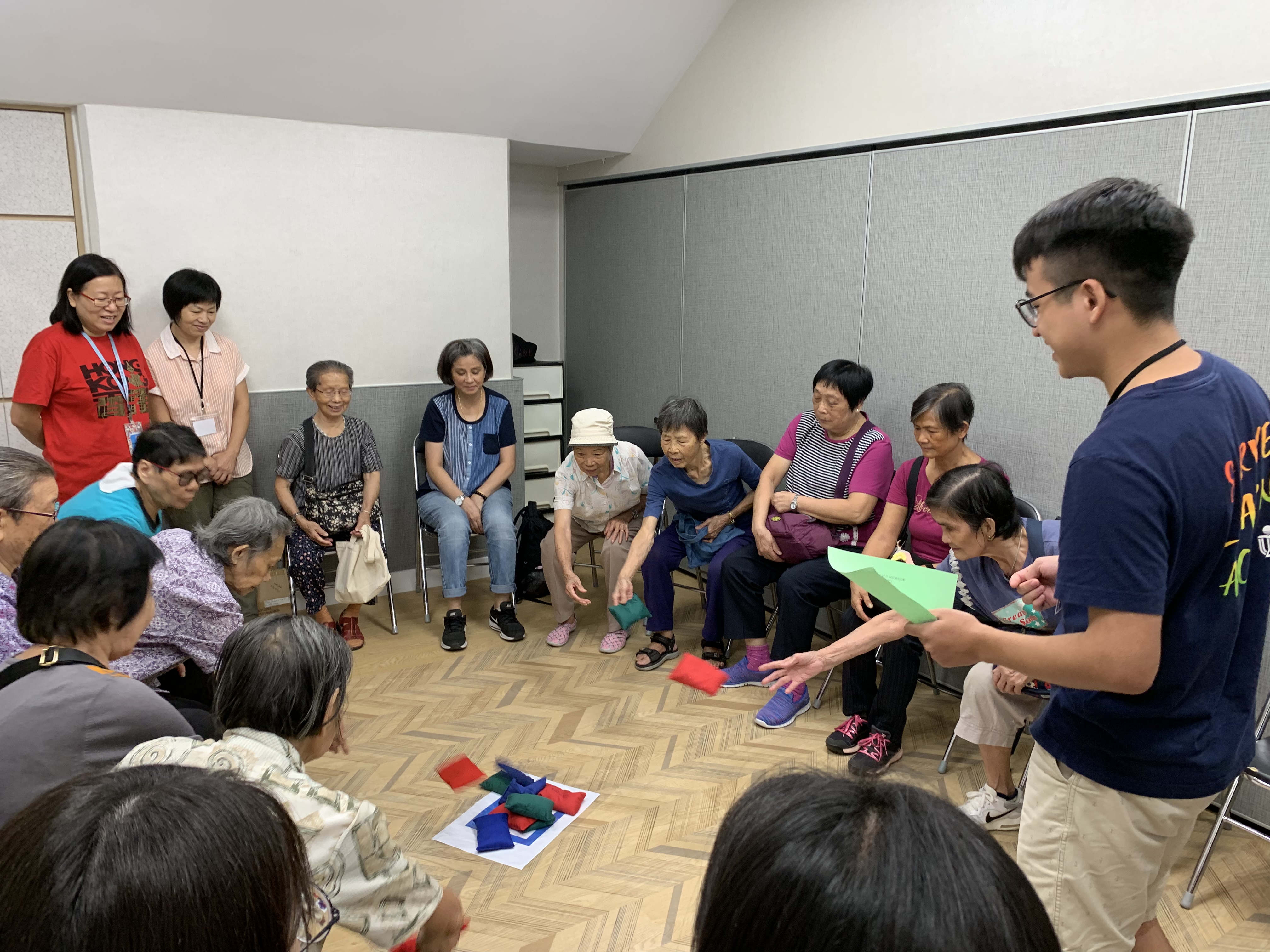 Student volunteers hosted interactive games for the elderly seated in a circle