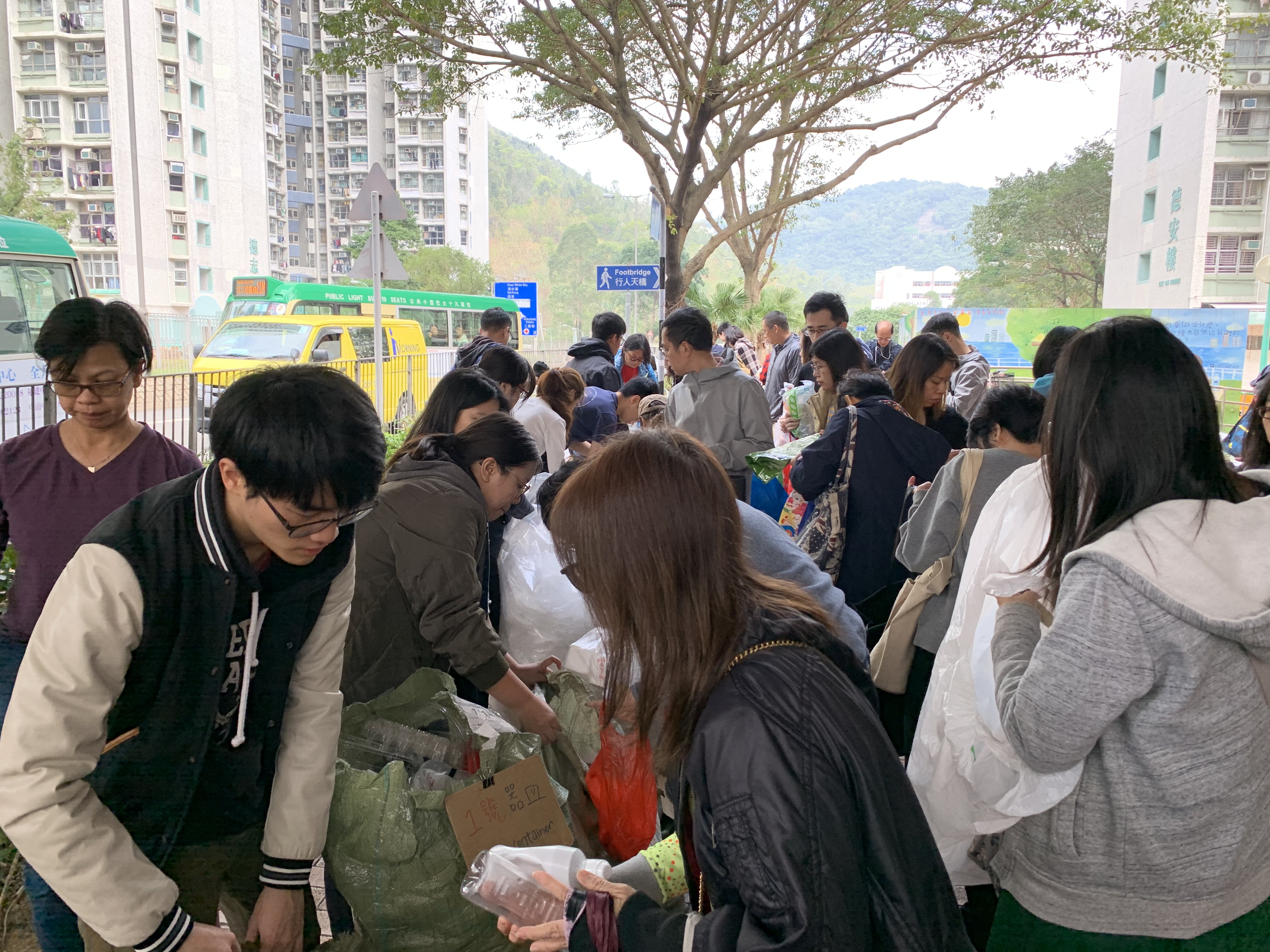 Volunteer teaching visitors to categorize plastic waste