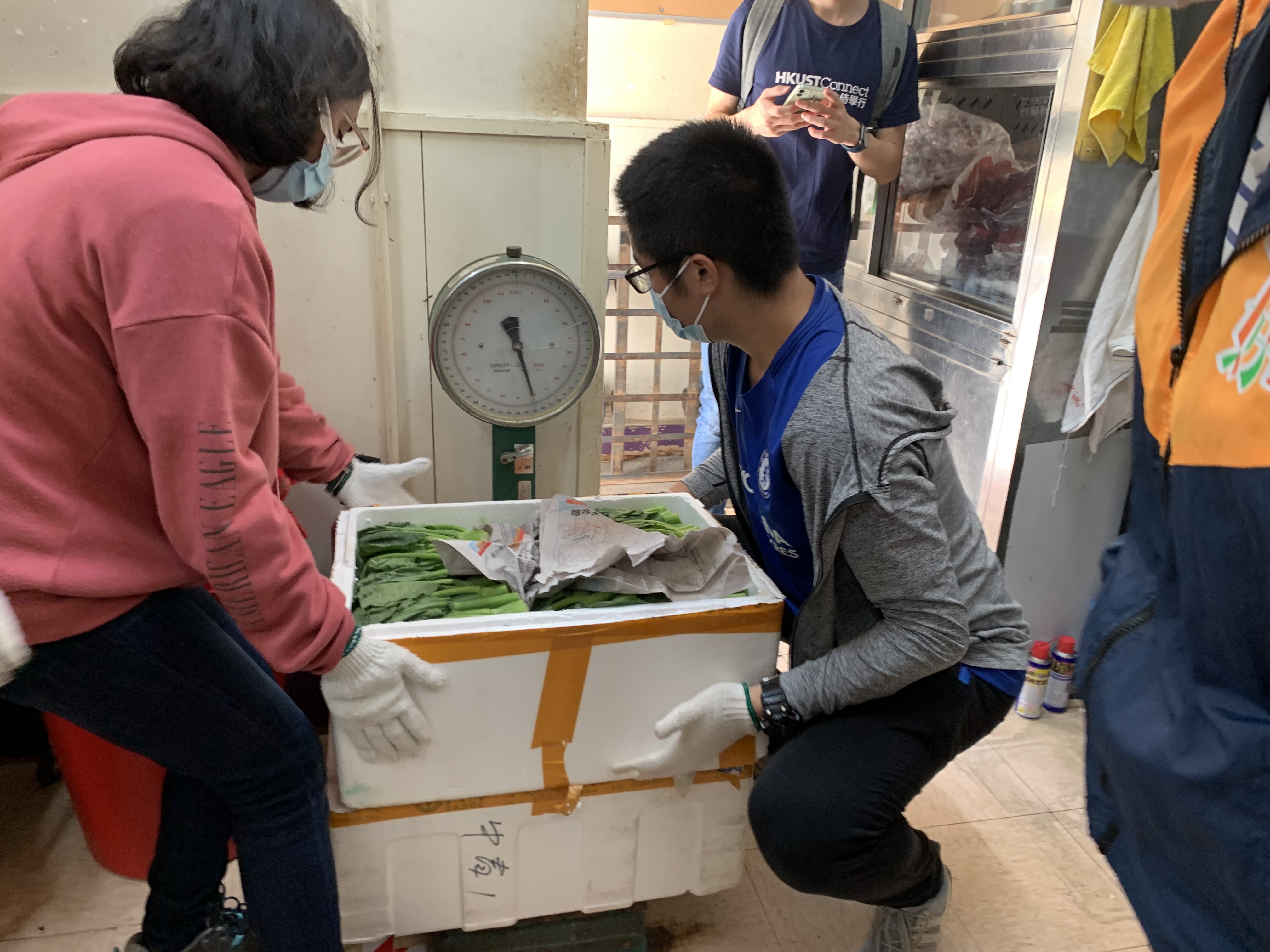 Volunteers are weighing the food collected.