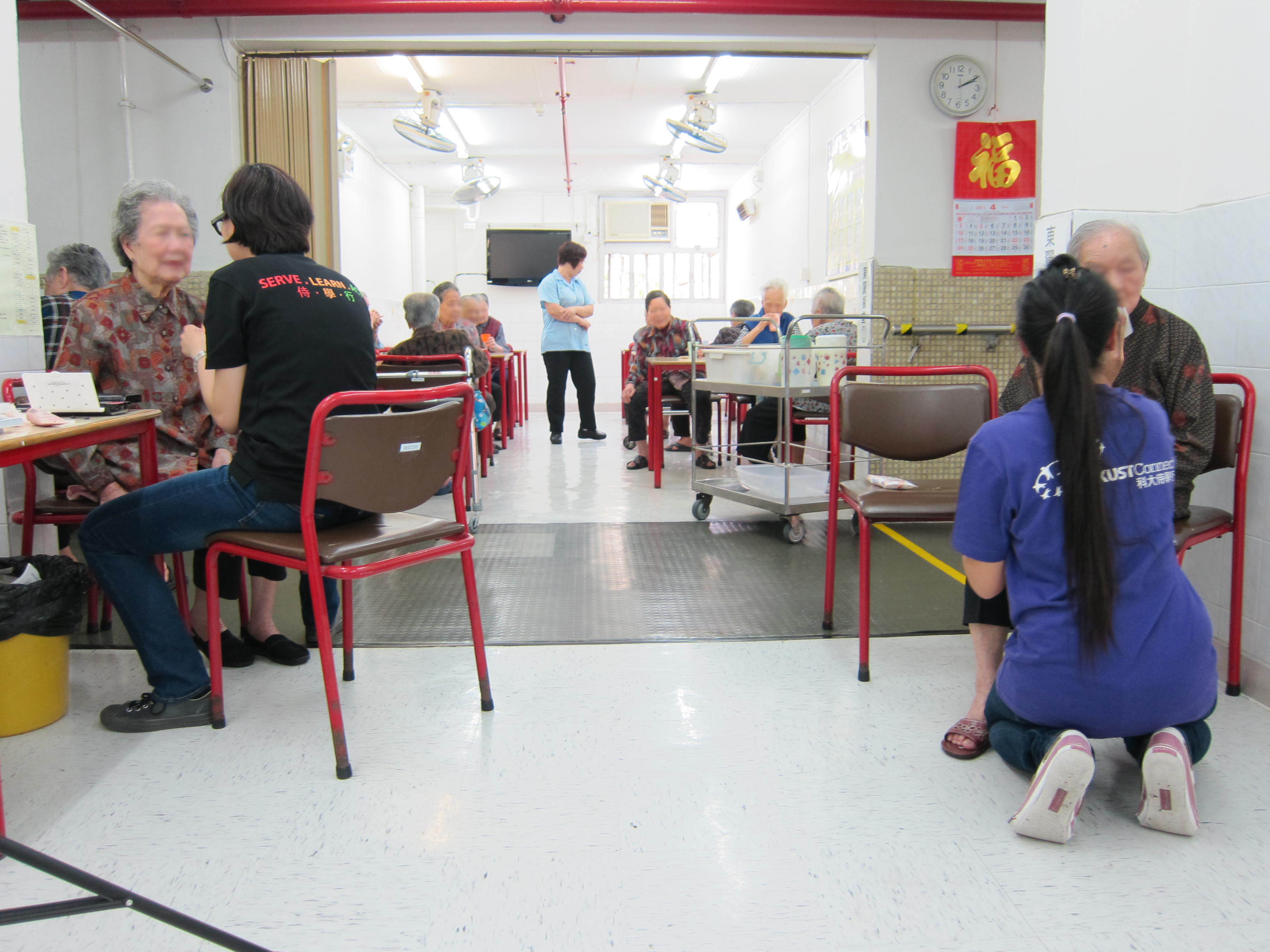 Volunteers putting on makeup for the elderly