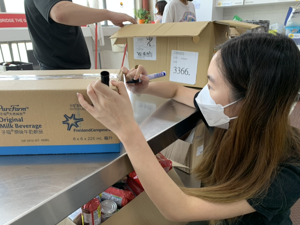 Volunteer is packing the food parcels