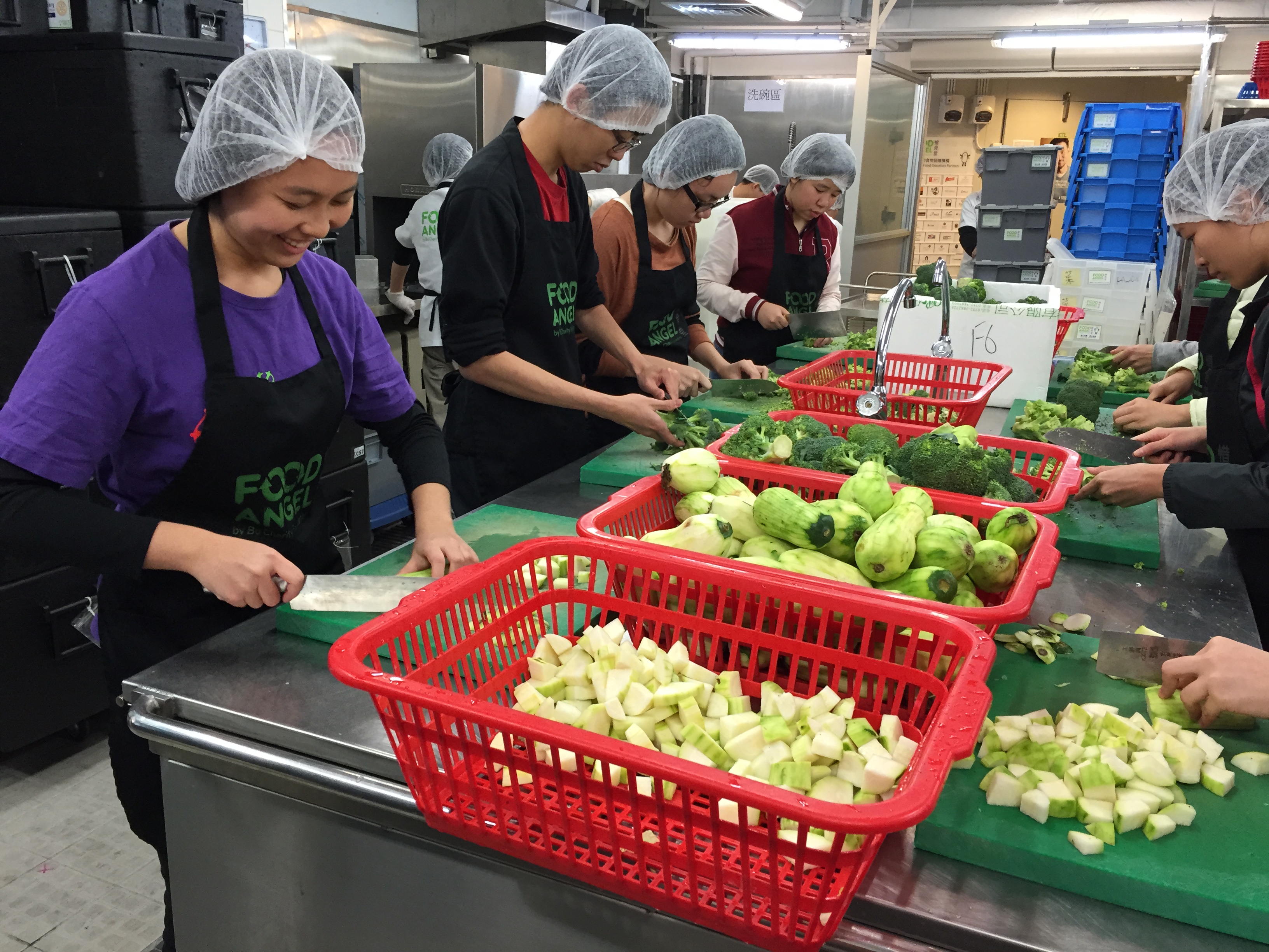 Volunteers preparing ingredients for Food Angel