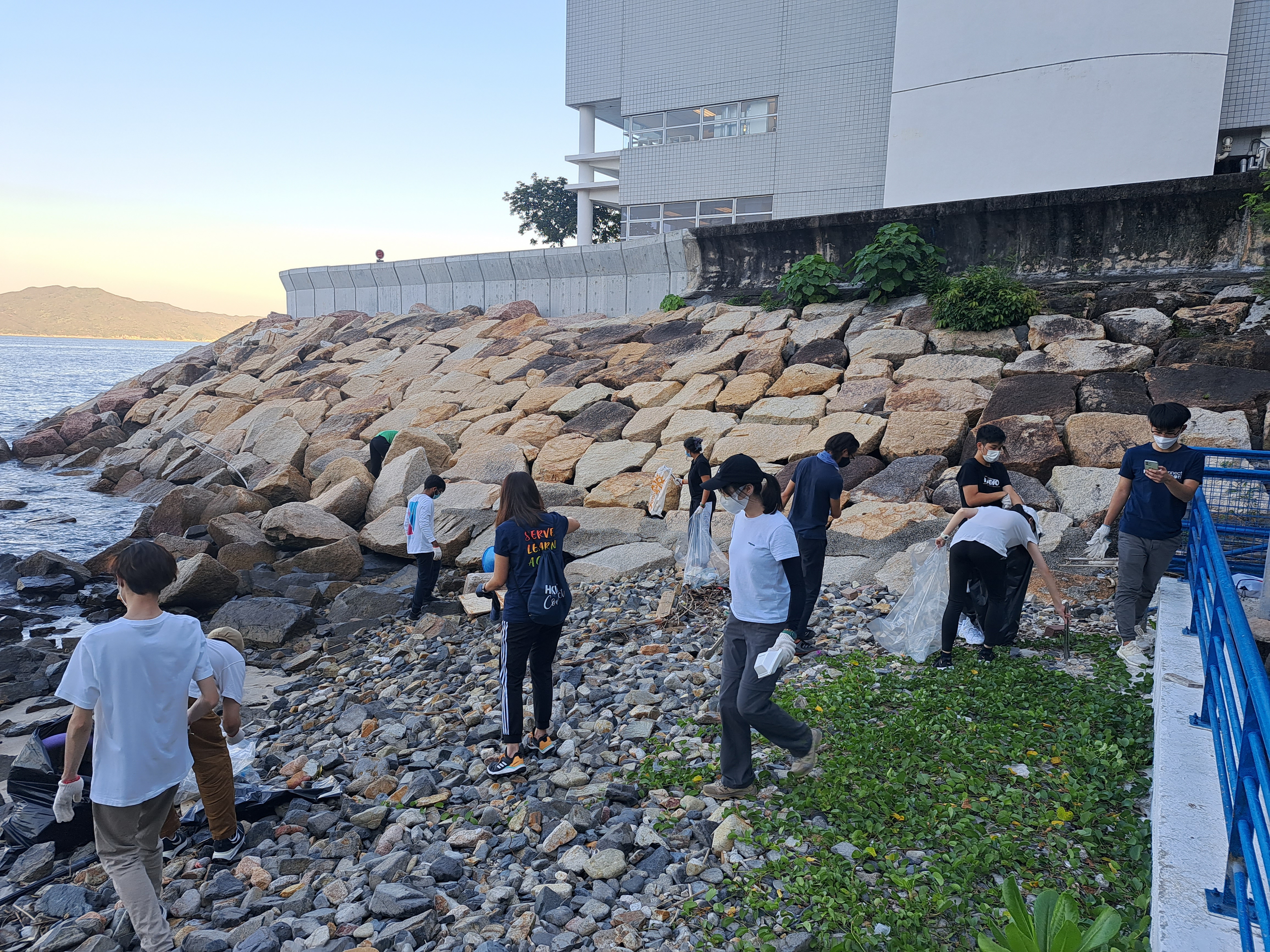 Volunteers picking up trash on the beach.