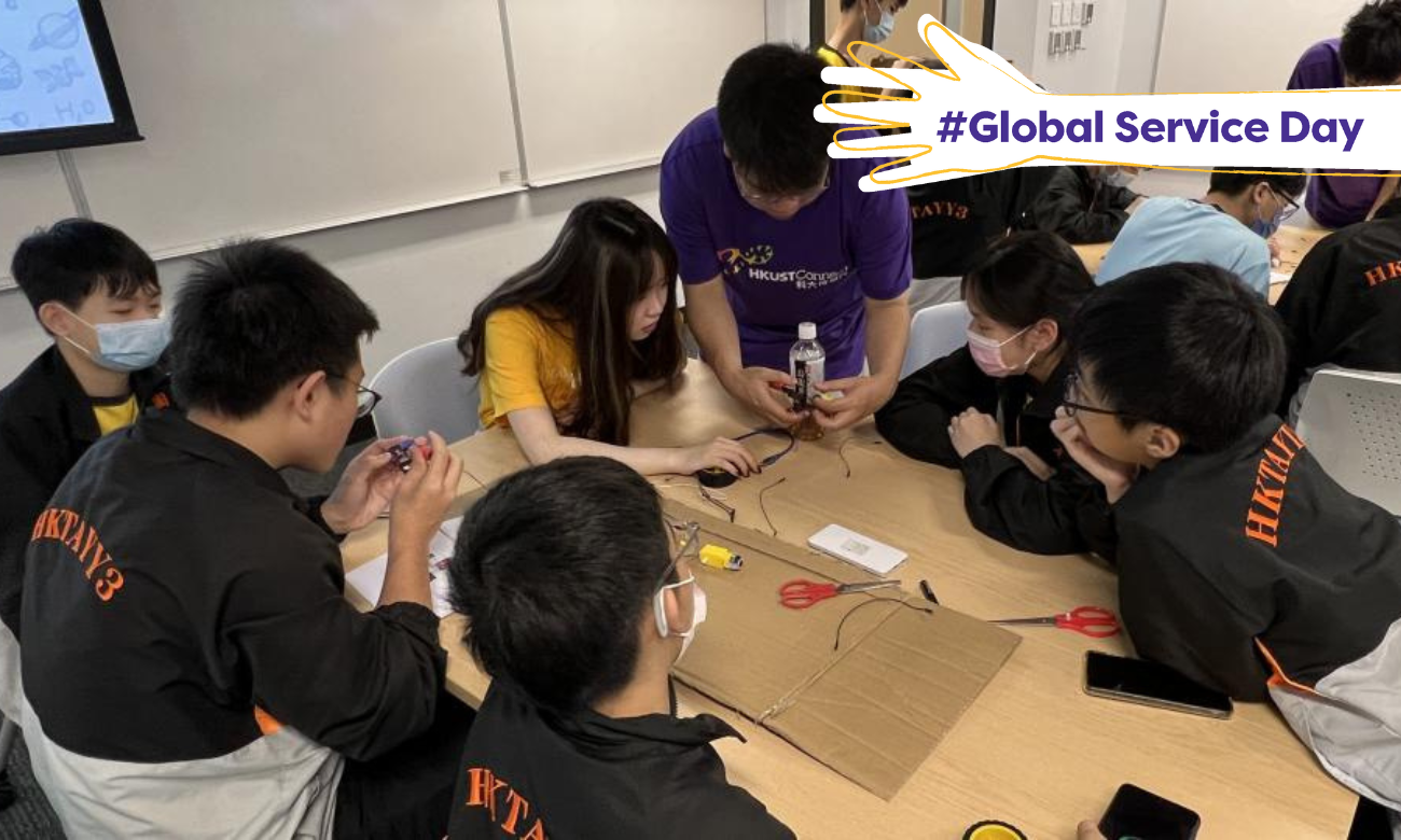 Volunteers helping students with their STEM project.