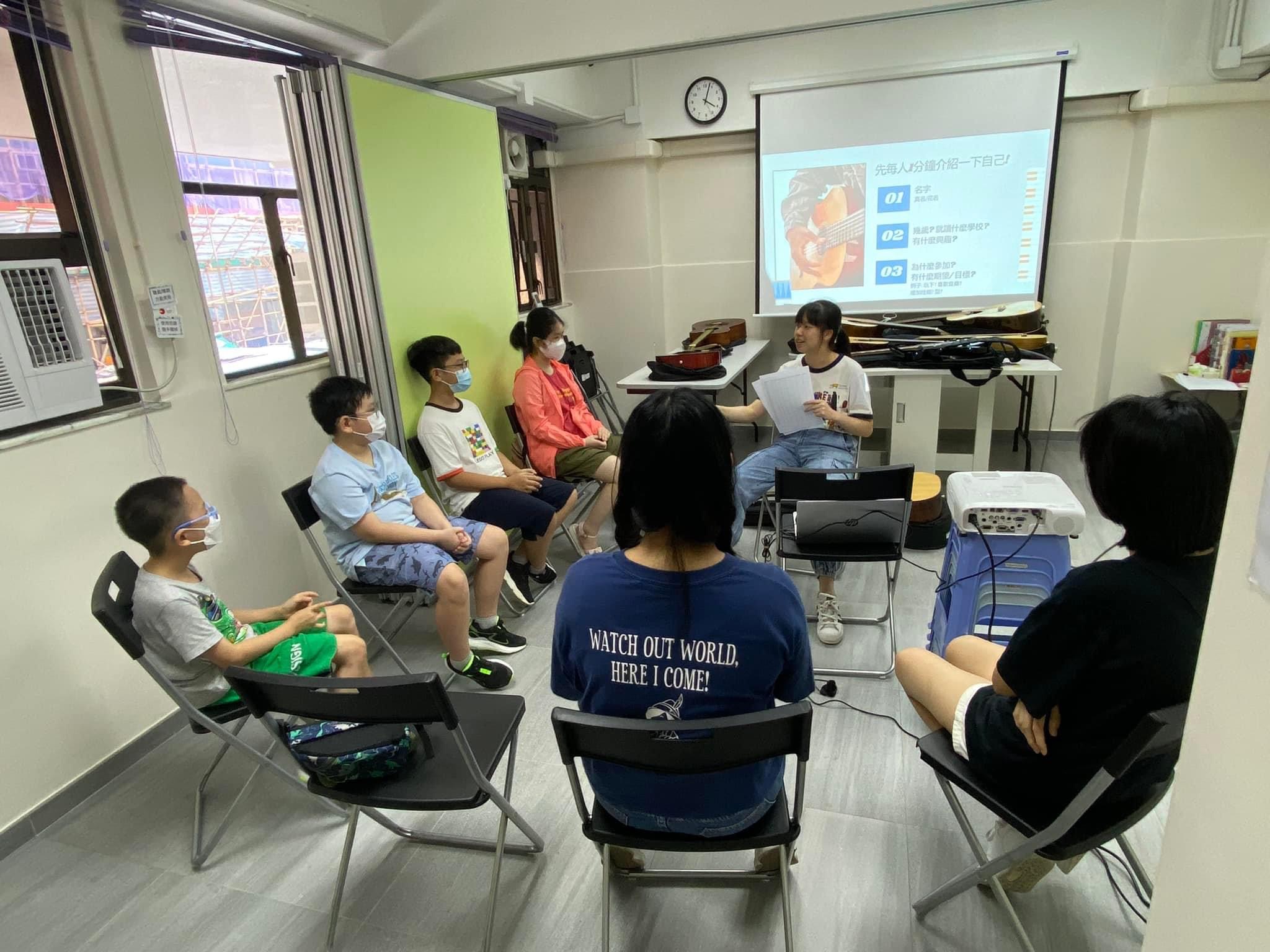 civic fellow holding guitar workshop for children
