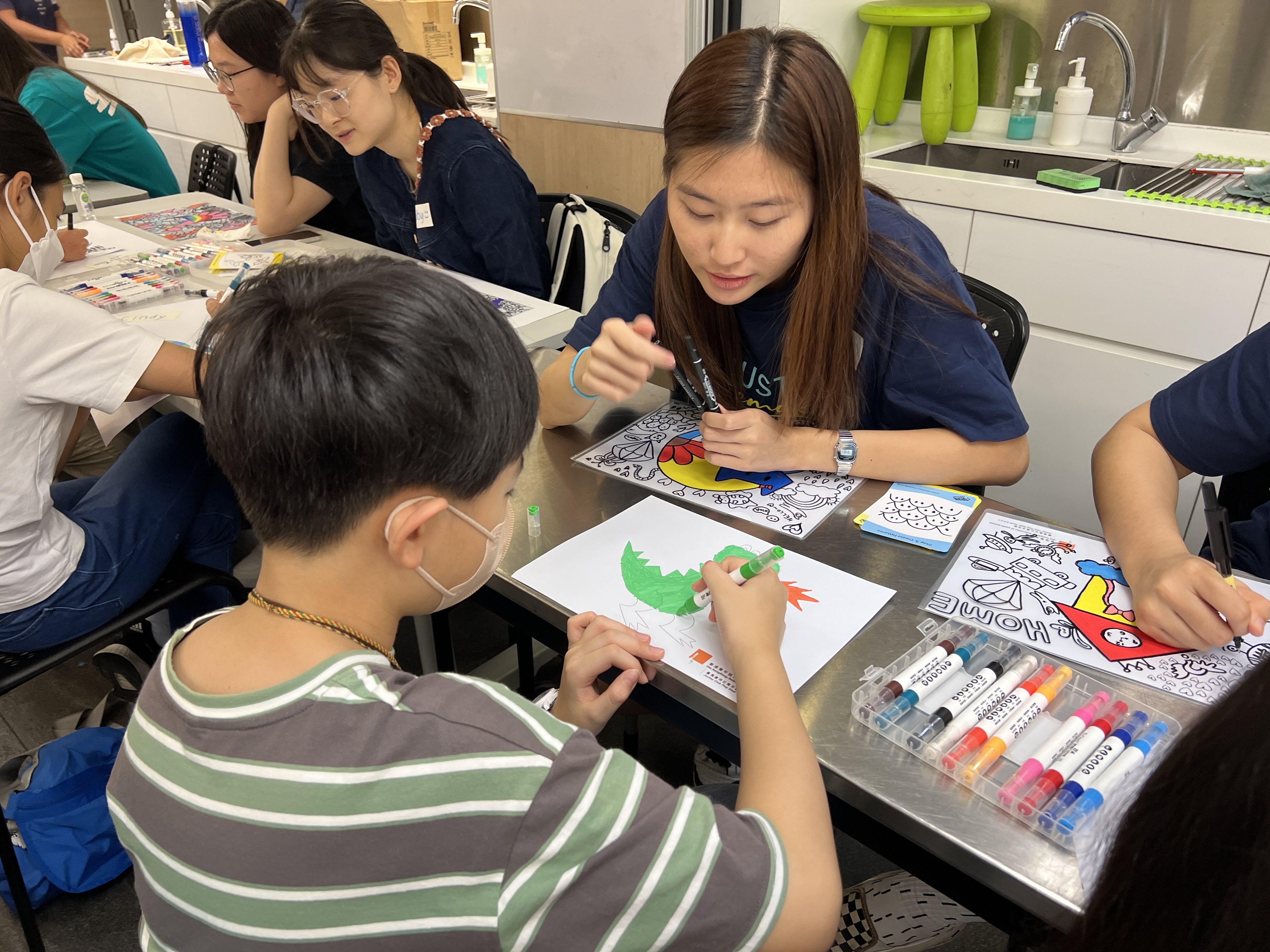 Volunteer coaching a child drawing