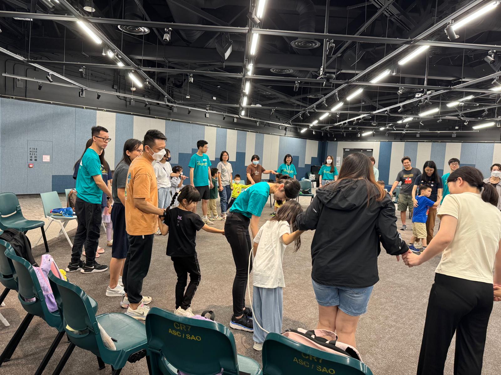 All volunteers and families play checkpoint game together