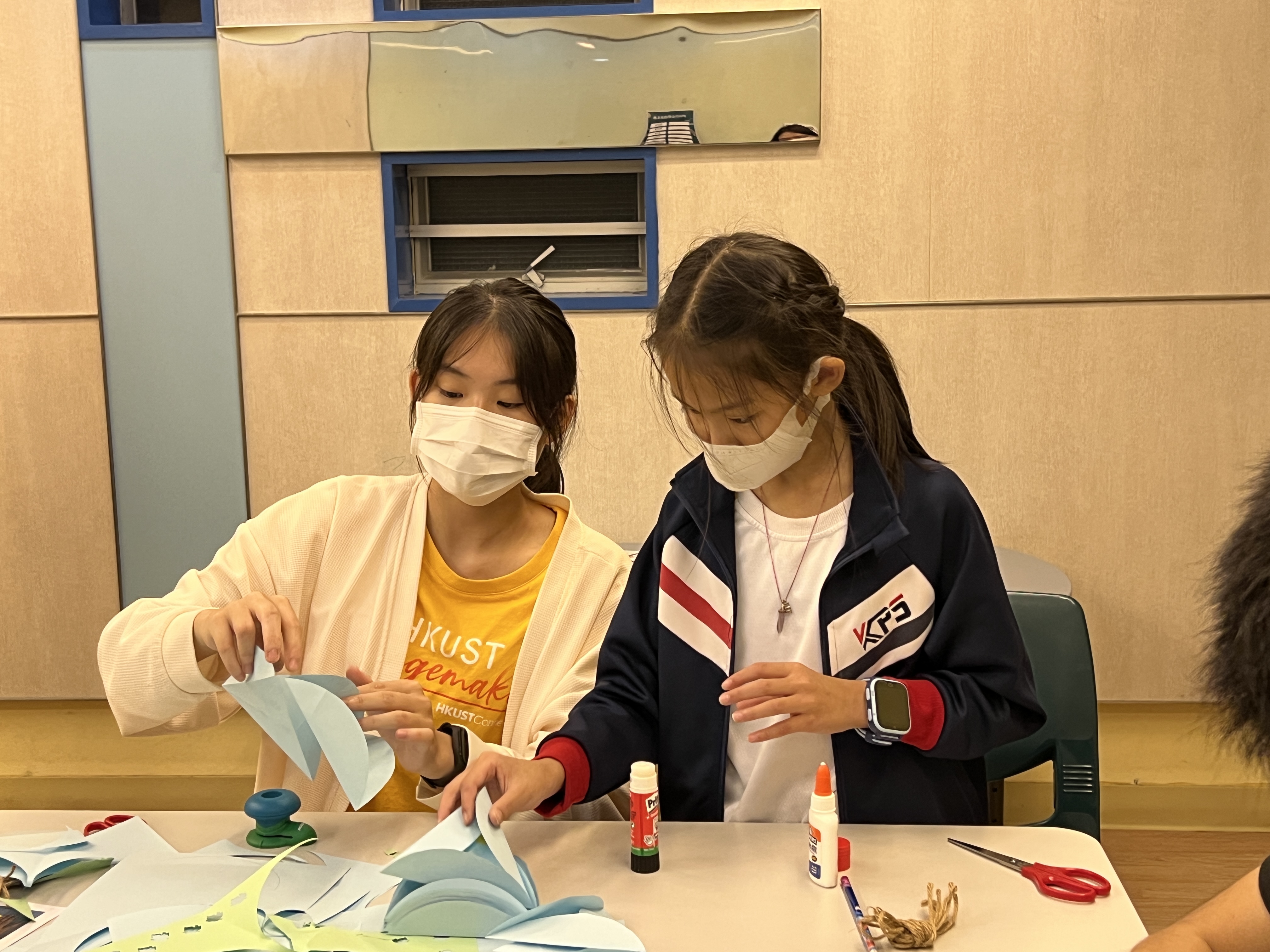 Volunteer making lanterns with the participant