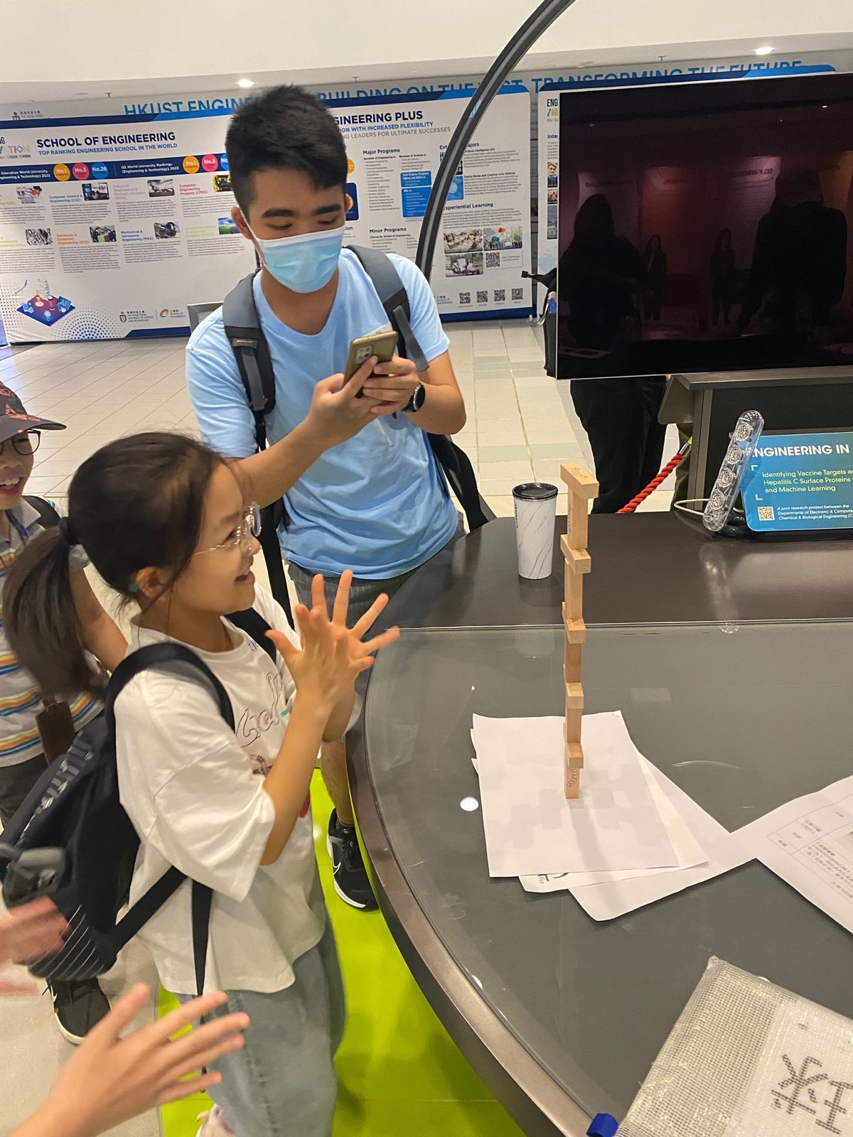 Children playing Jenga with volunteers