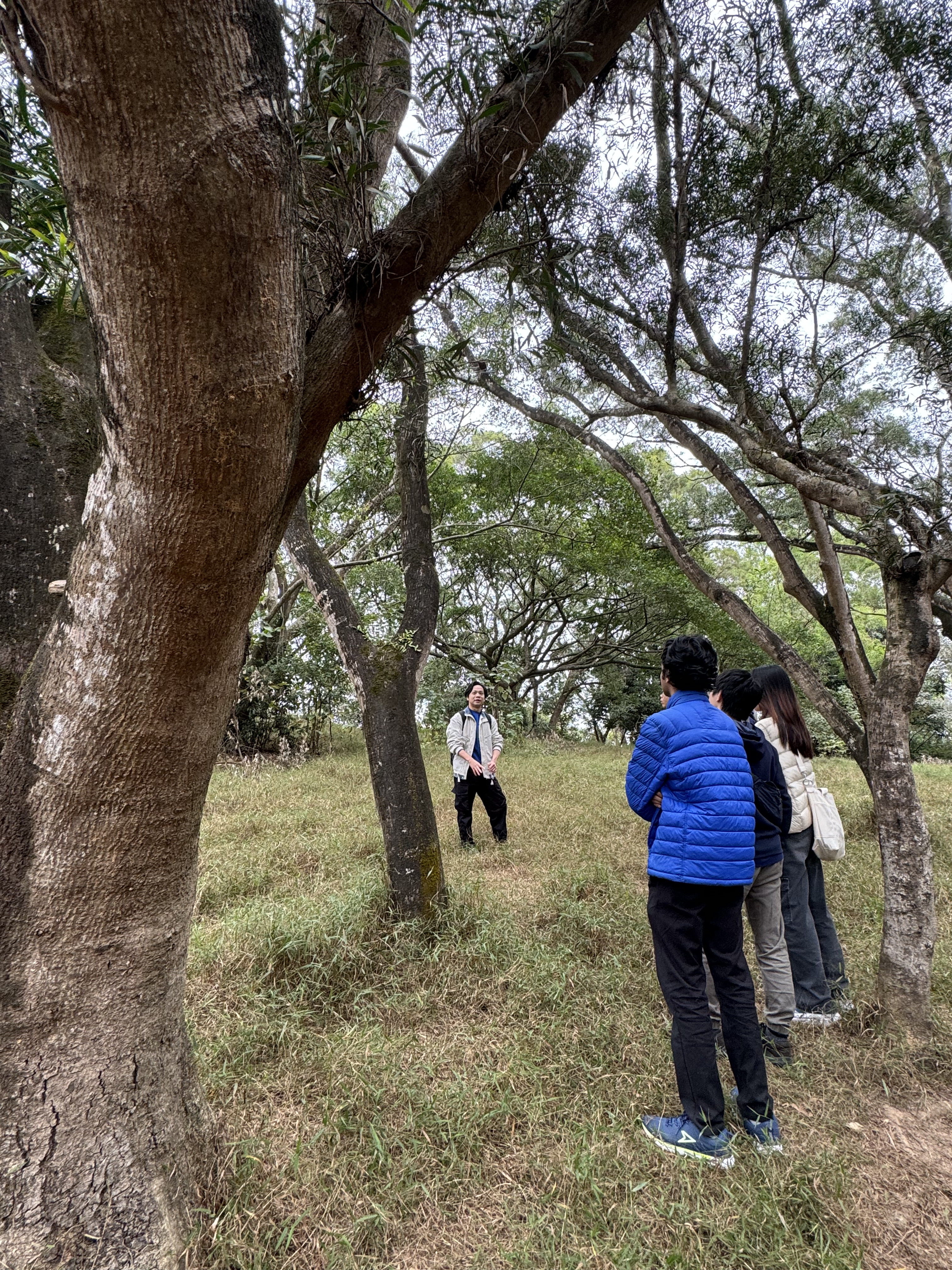 The guide explaining interconnectedness of nature and community to the students