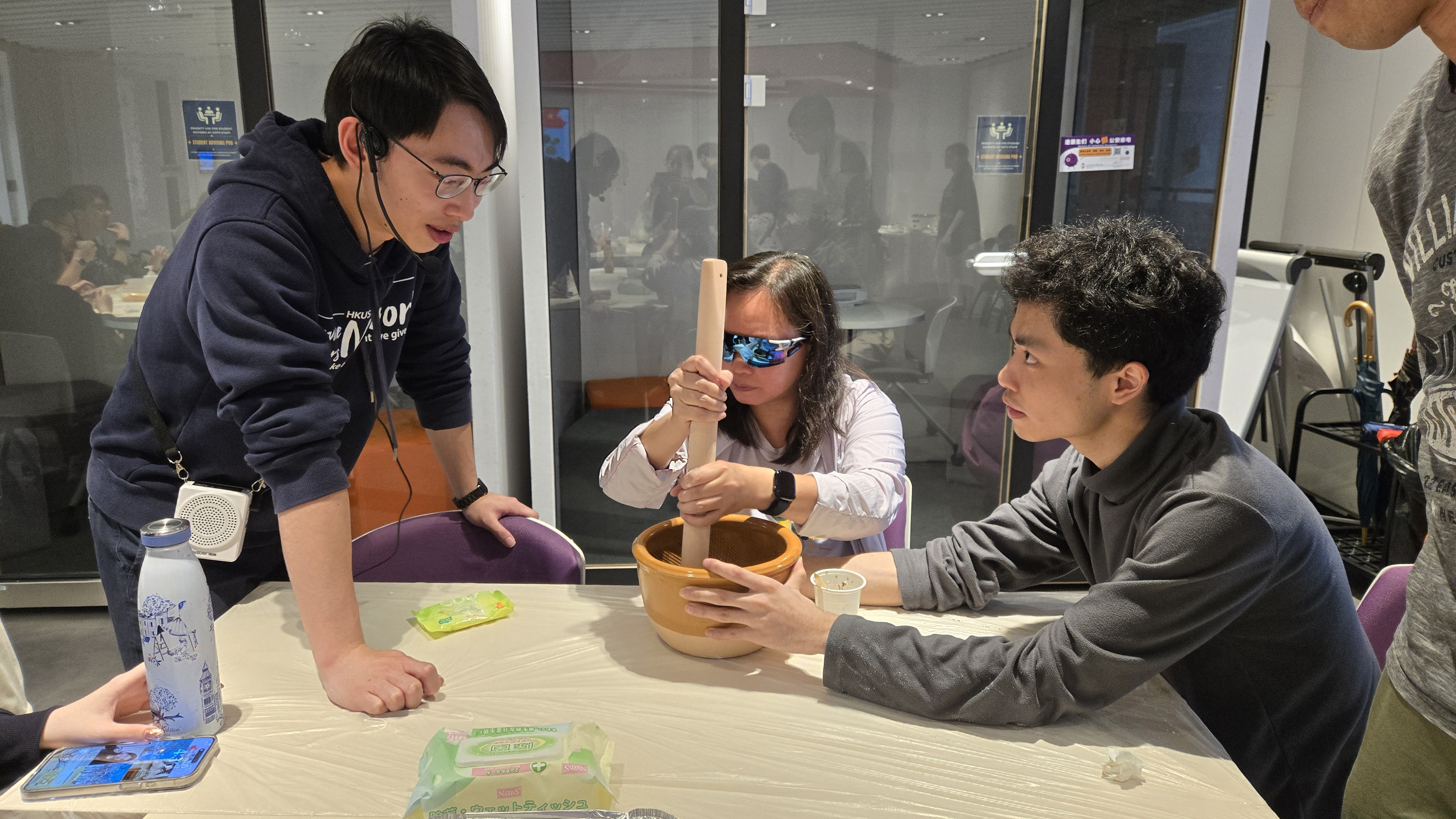Volunteers assisting a VIP in hands-on experience of making Leicha