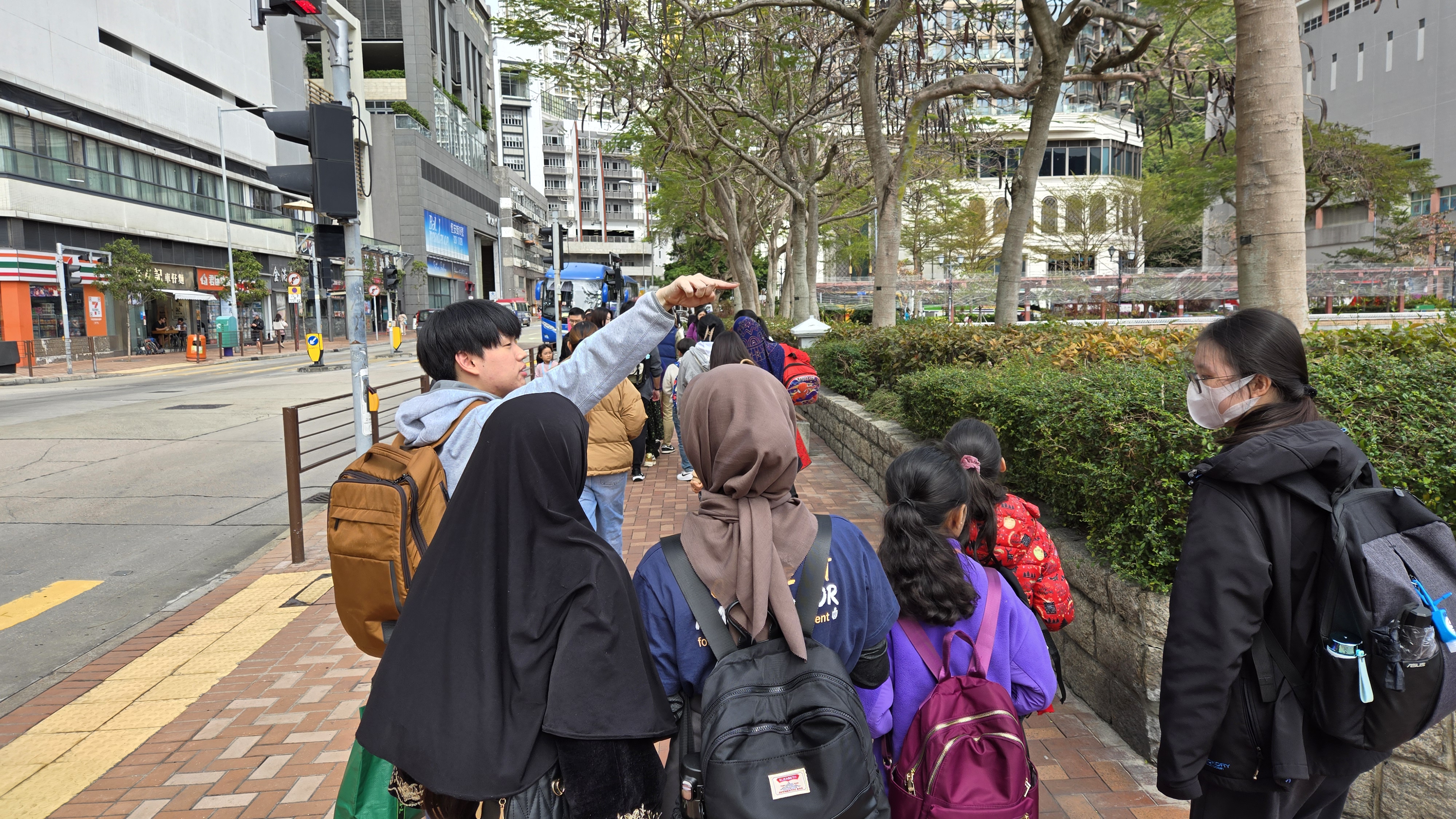 Volunteers accompanying ethnic minority children to hiking trail cleaning in Lei Yu Mun 