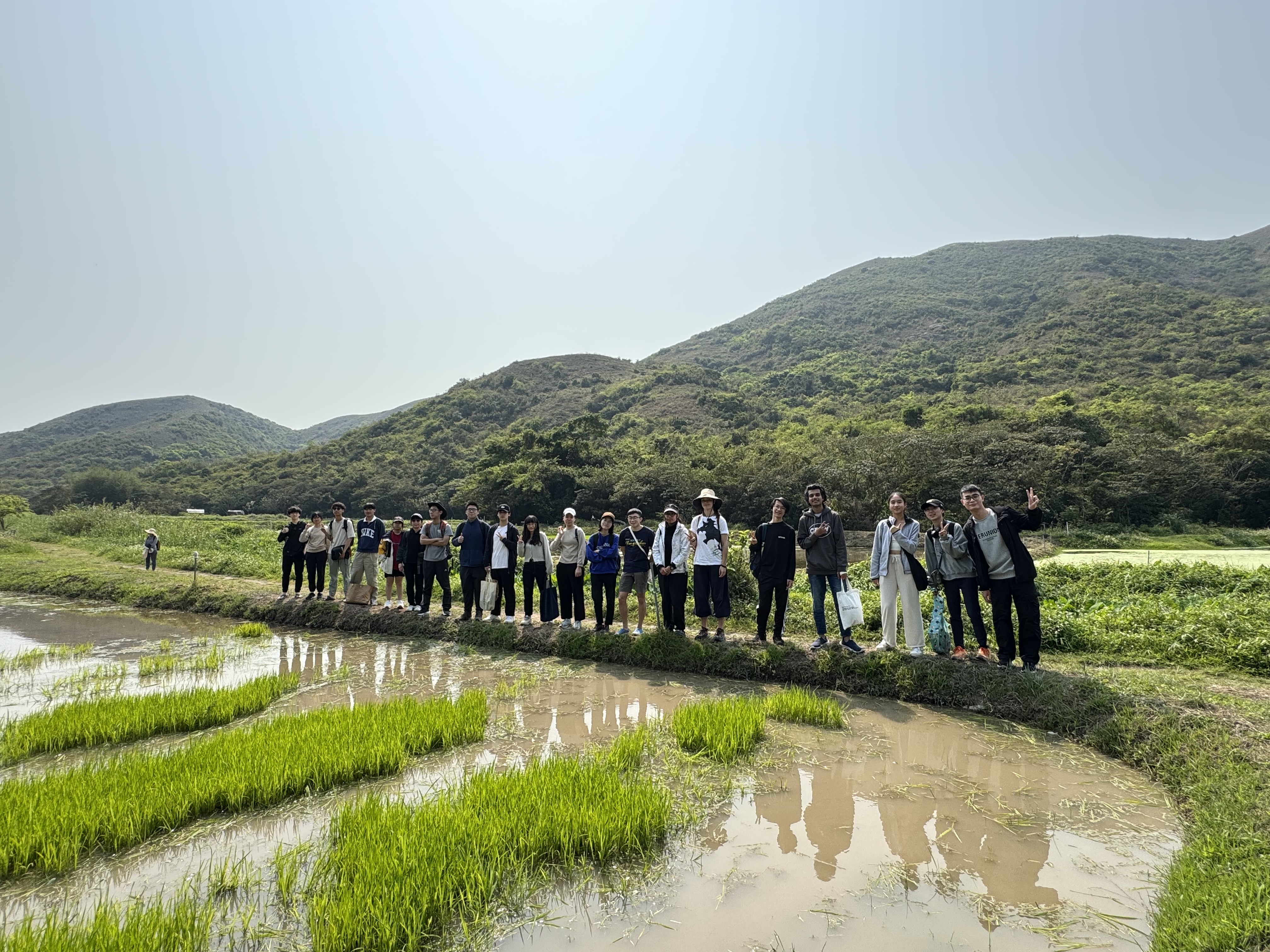 Celebrating the joy of nature and friendship after a hard day's work planting rice!