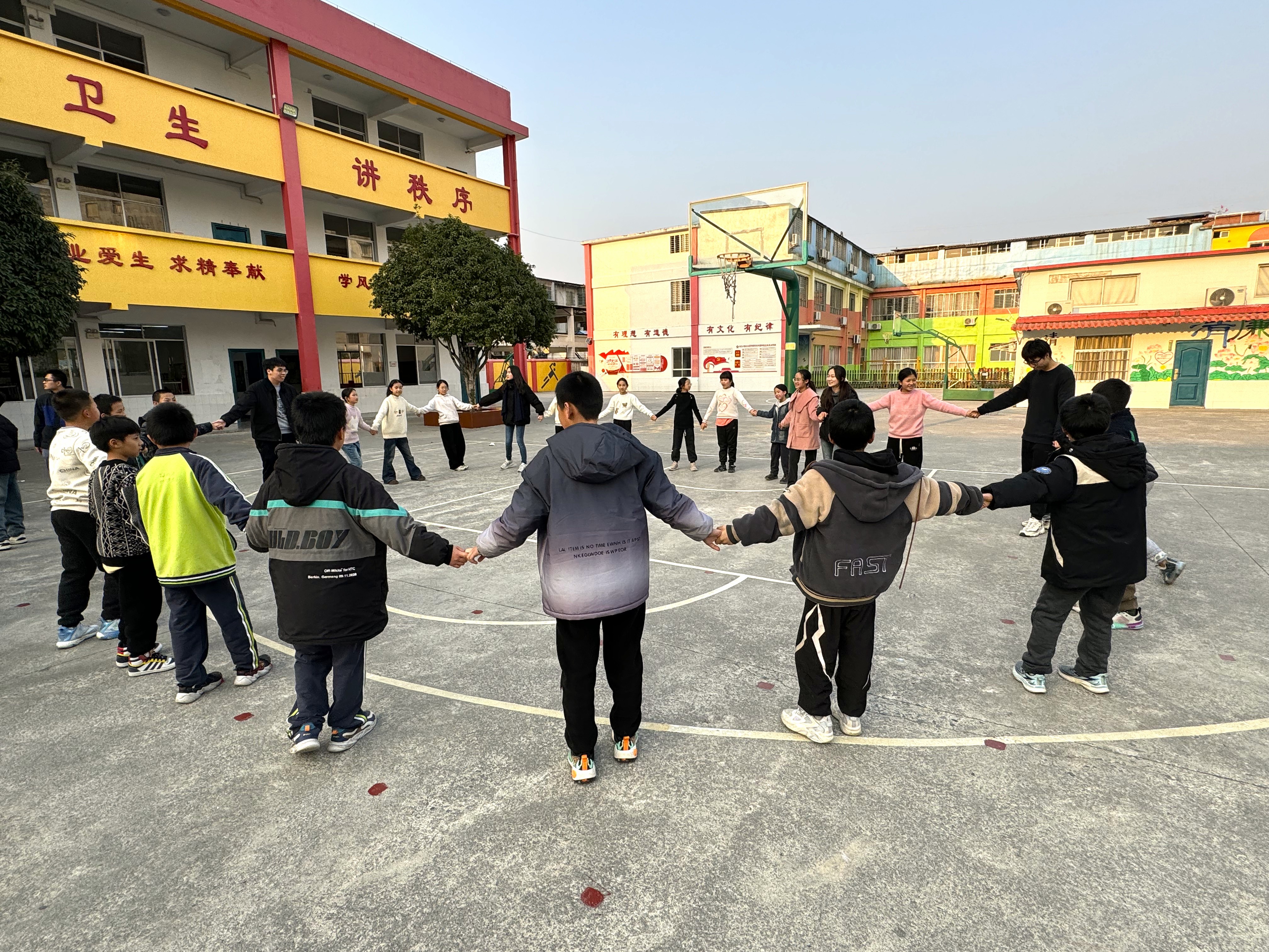 Volunteers playing mass game with Guilin students