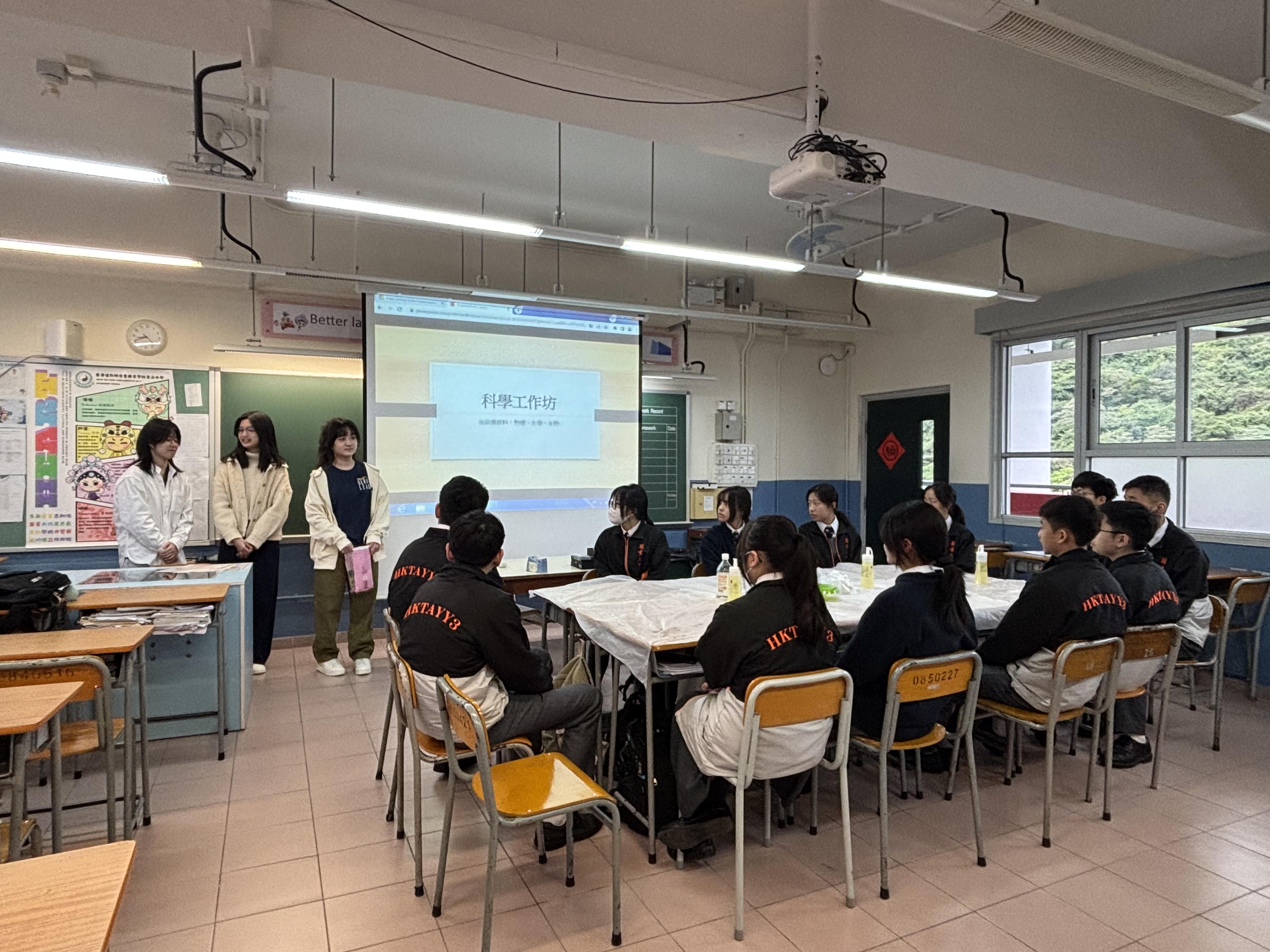 Volunteers providing science workshop to secondary students