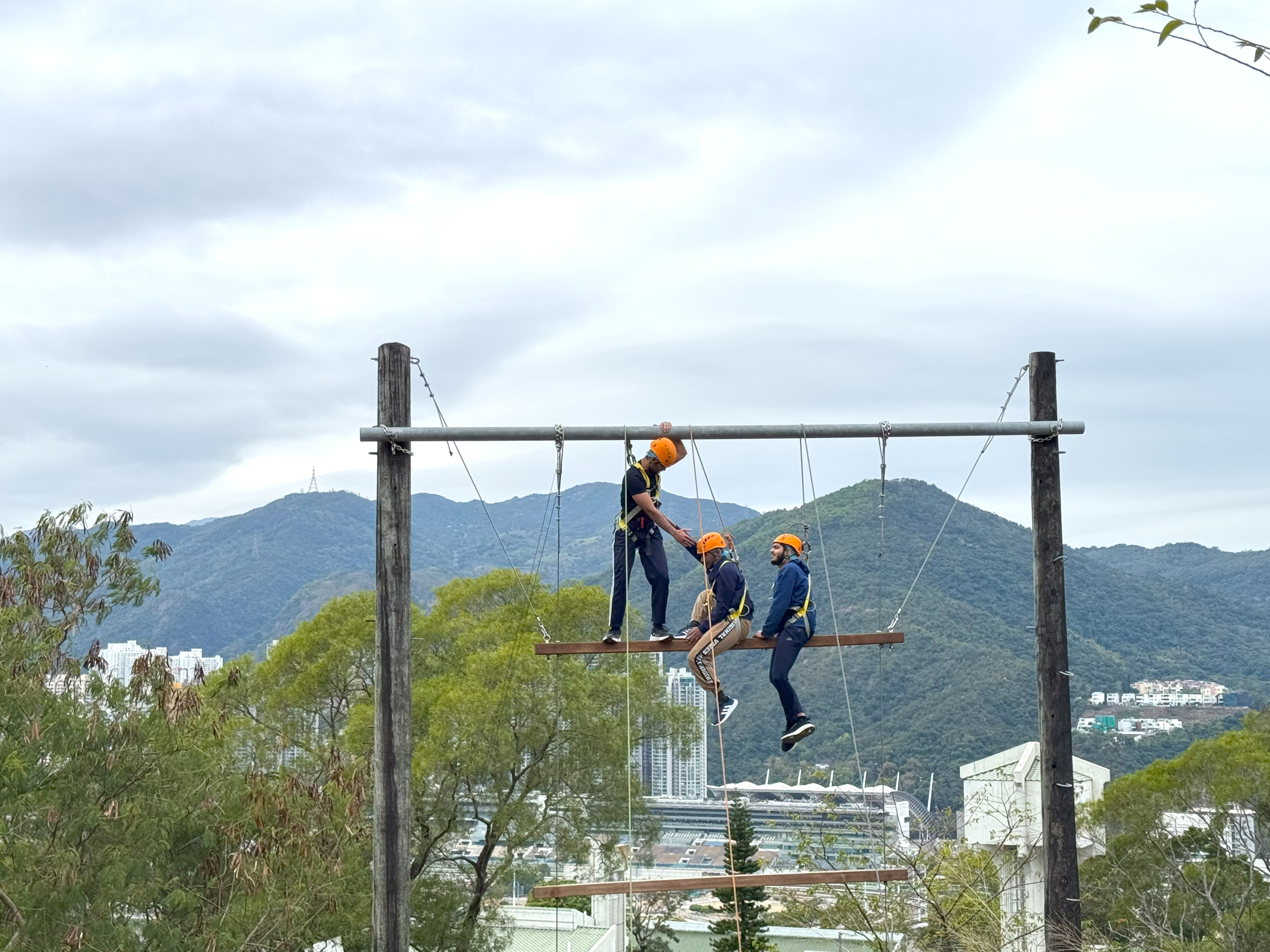 Teamwork in action, embracing the thrill and trust as they tackle the challenge together