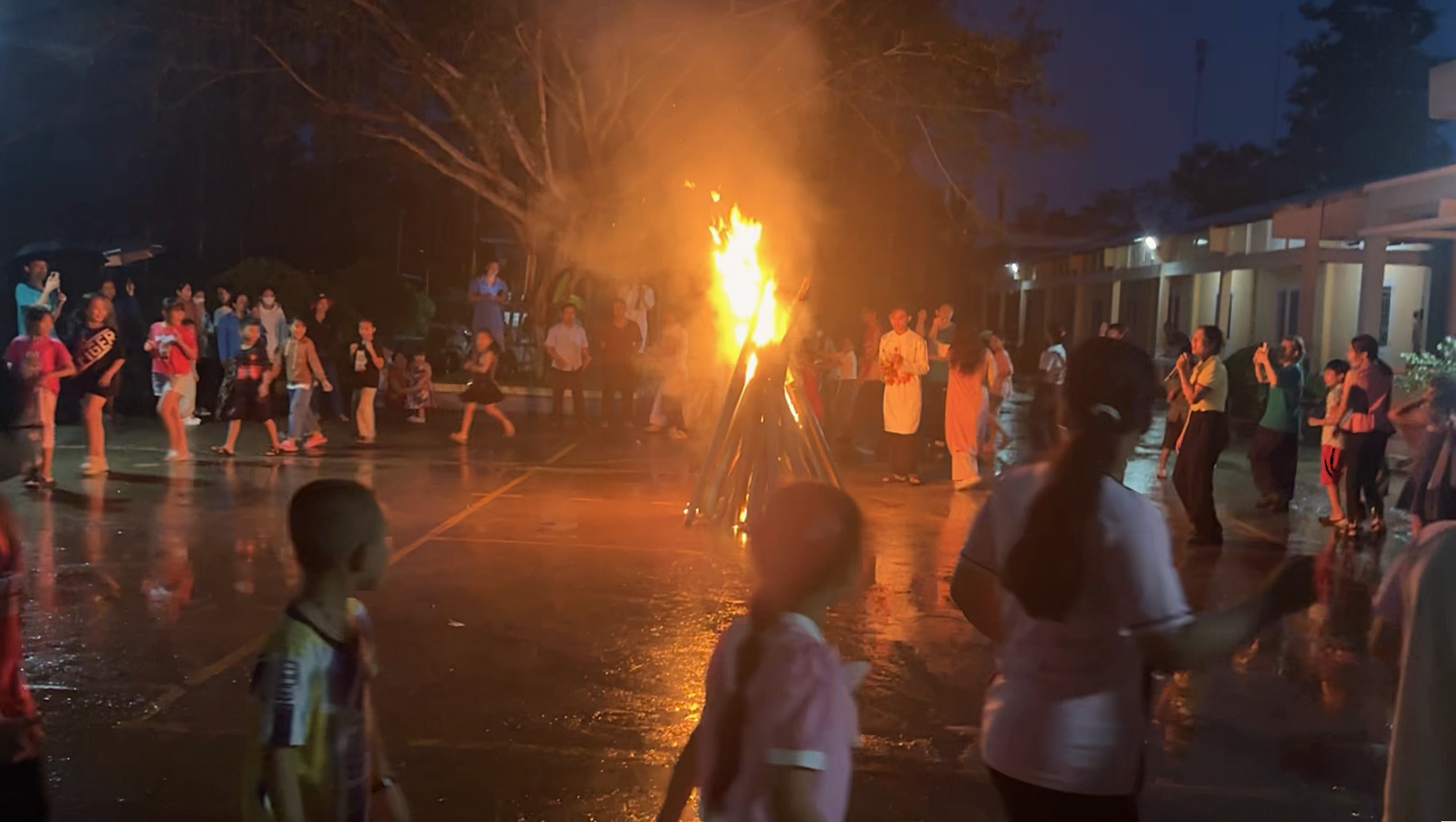 Children and volunteers having farewell campfire