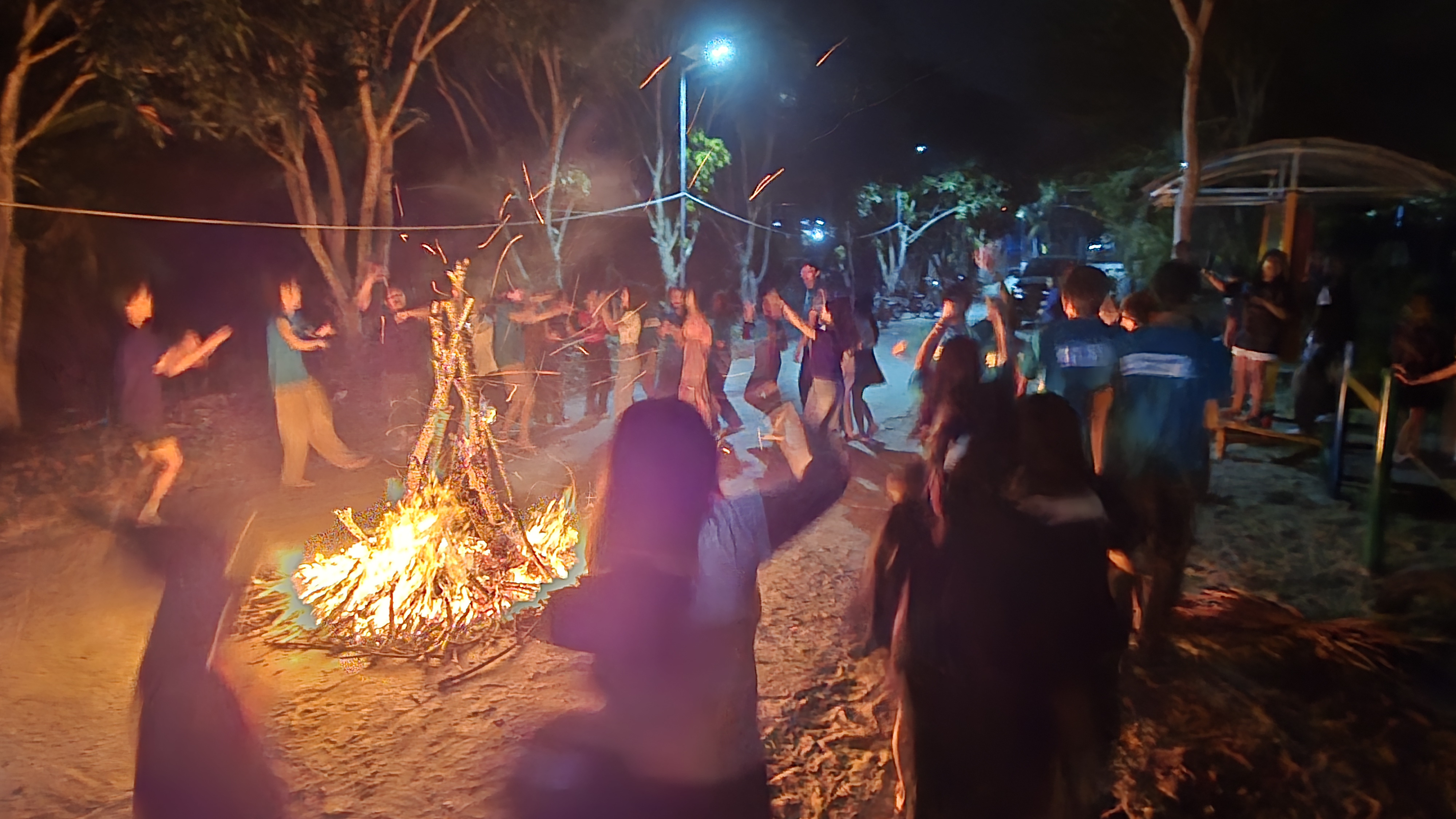 Volunteers and local youth enjoying a campfire night together