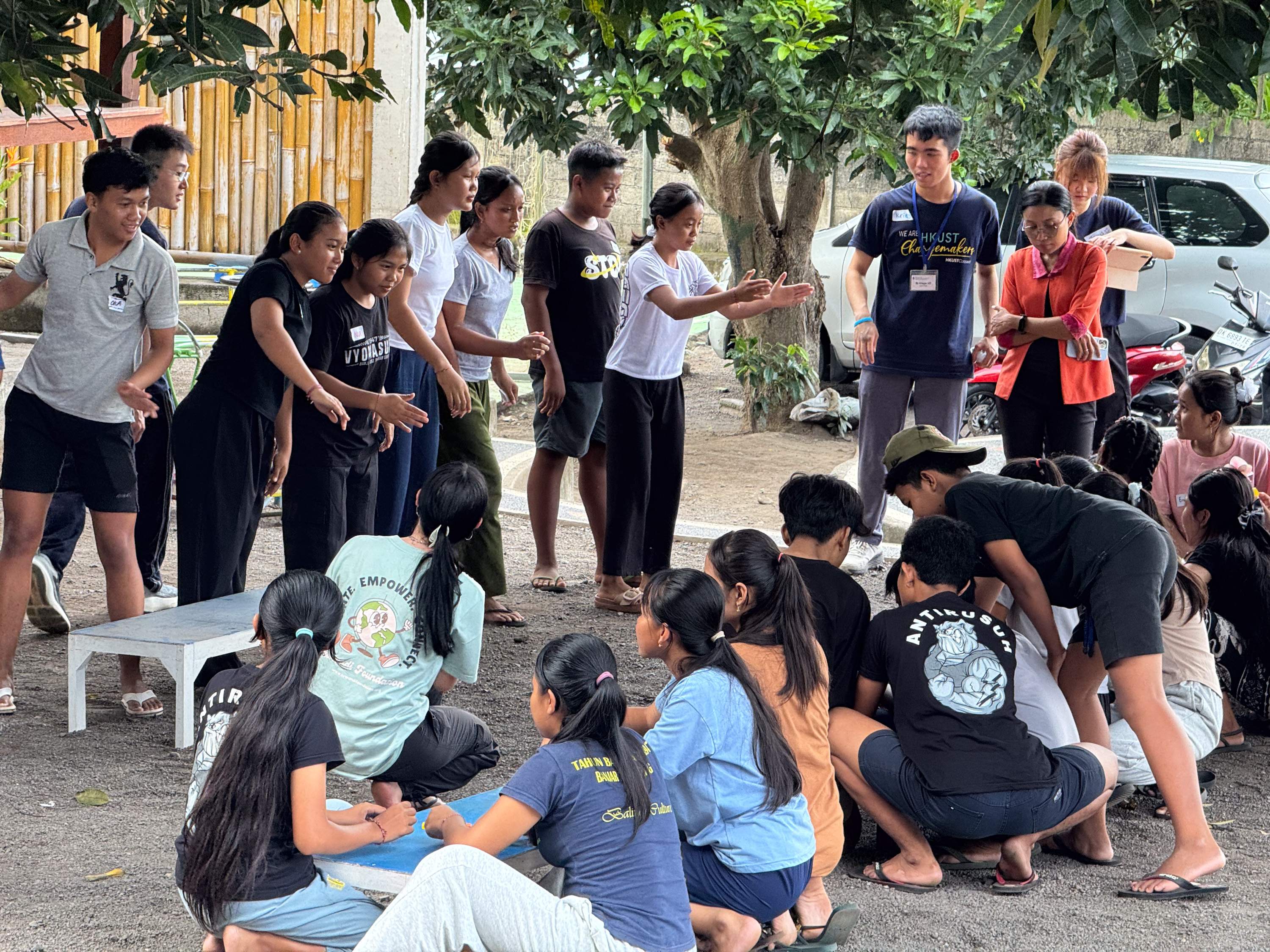 Volunteers guiding secondary students to develop problem-solving skills through interactive activities