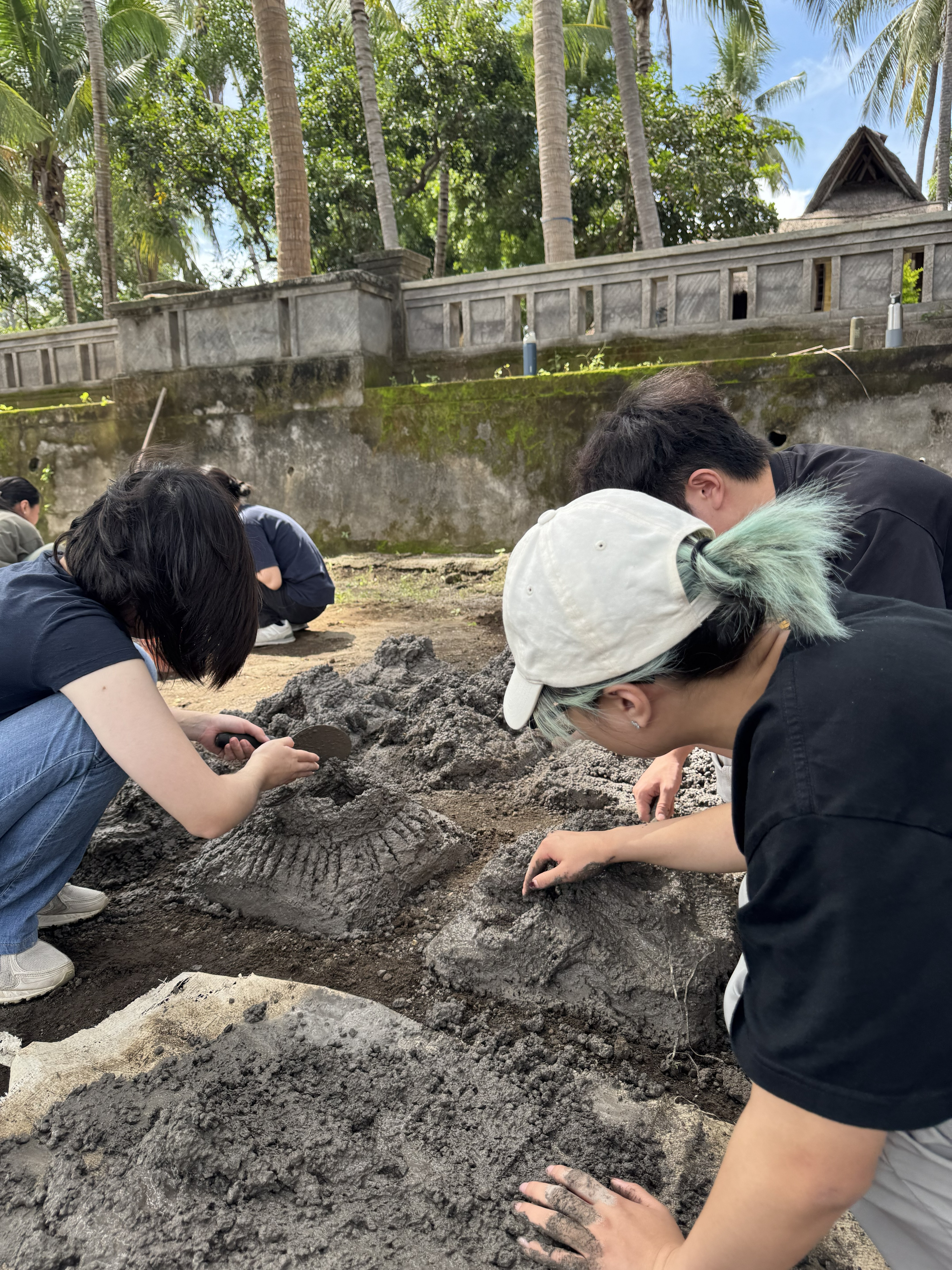 Volunteers experiencing the process of making artificial corals