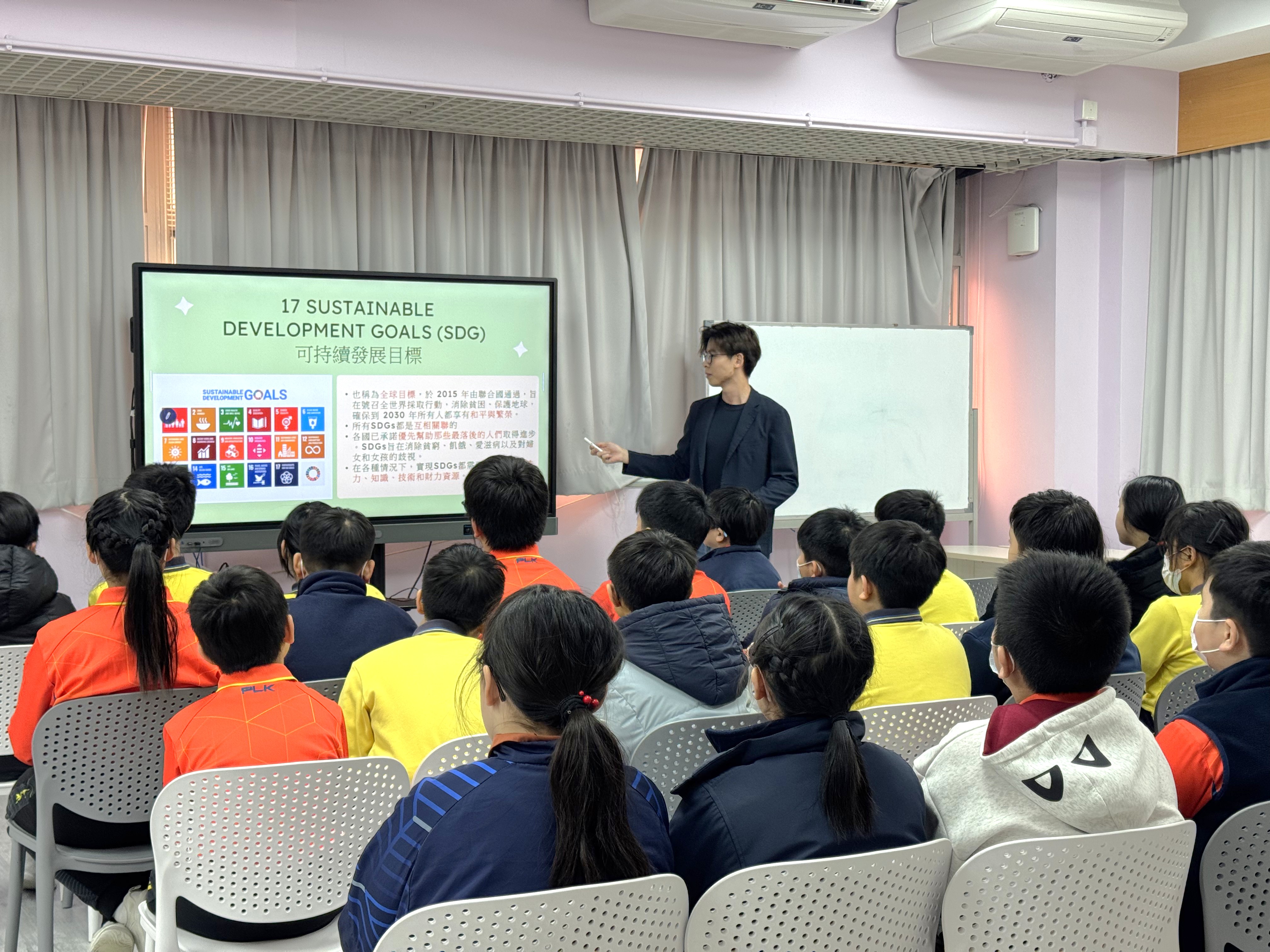Volunteer teaching students about the Sustainable Development Goals (SDGs)