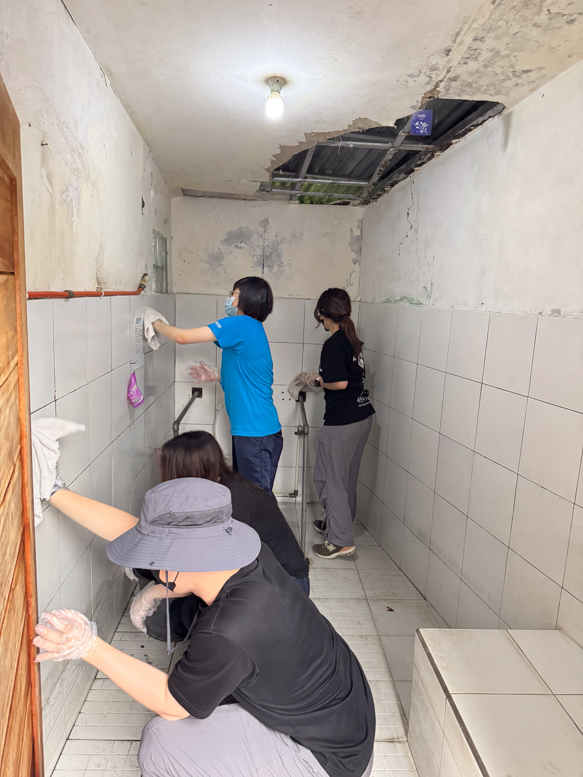 Volunteers assisting residents with physical disabilities in cleaning activities