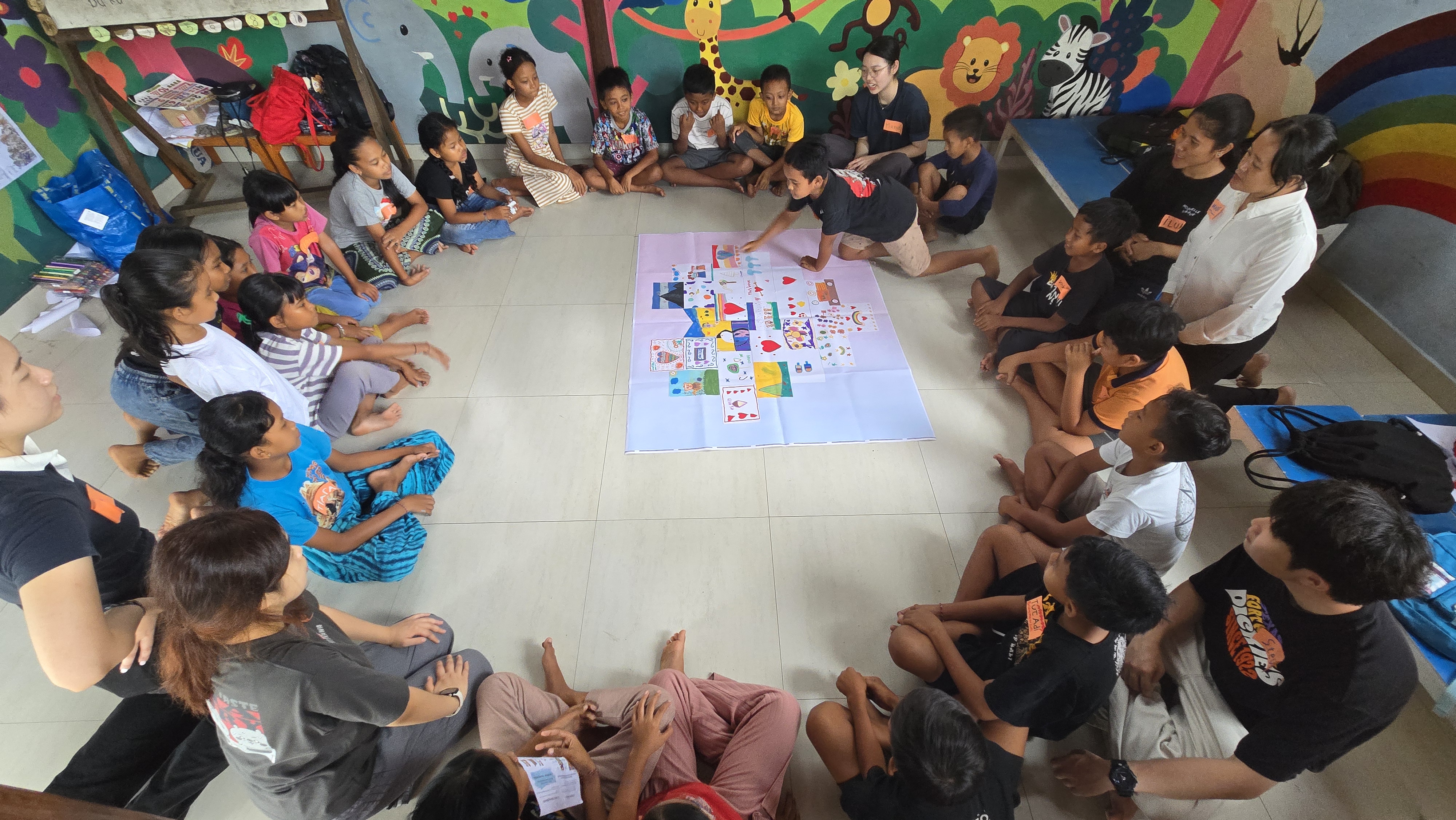 Volunteers co-creating artwork with primary school students at Suwandi Foundation