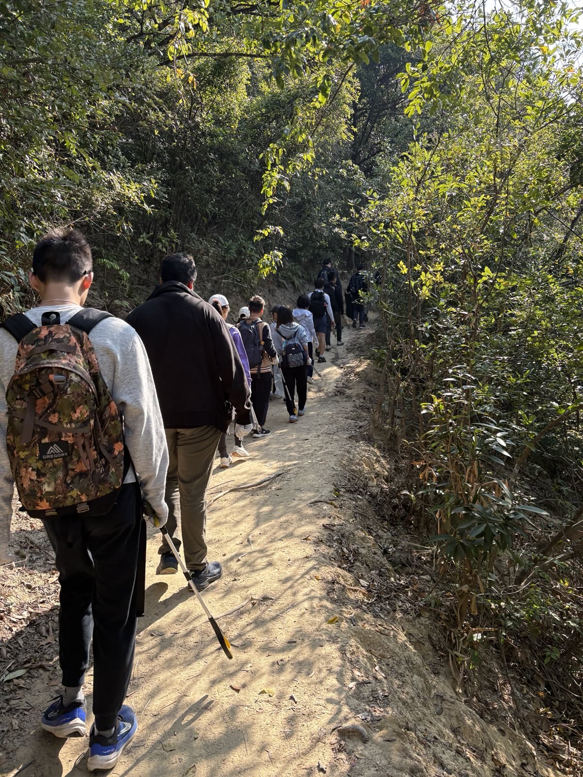 Volunteers scanning the trails for litter