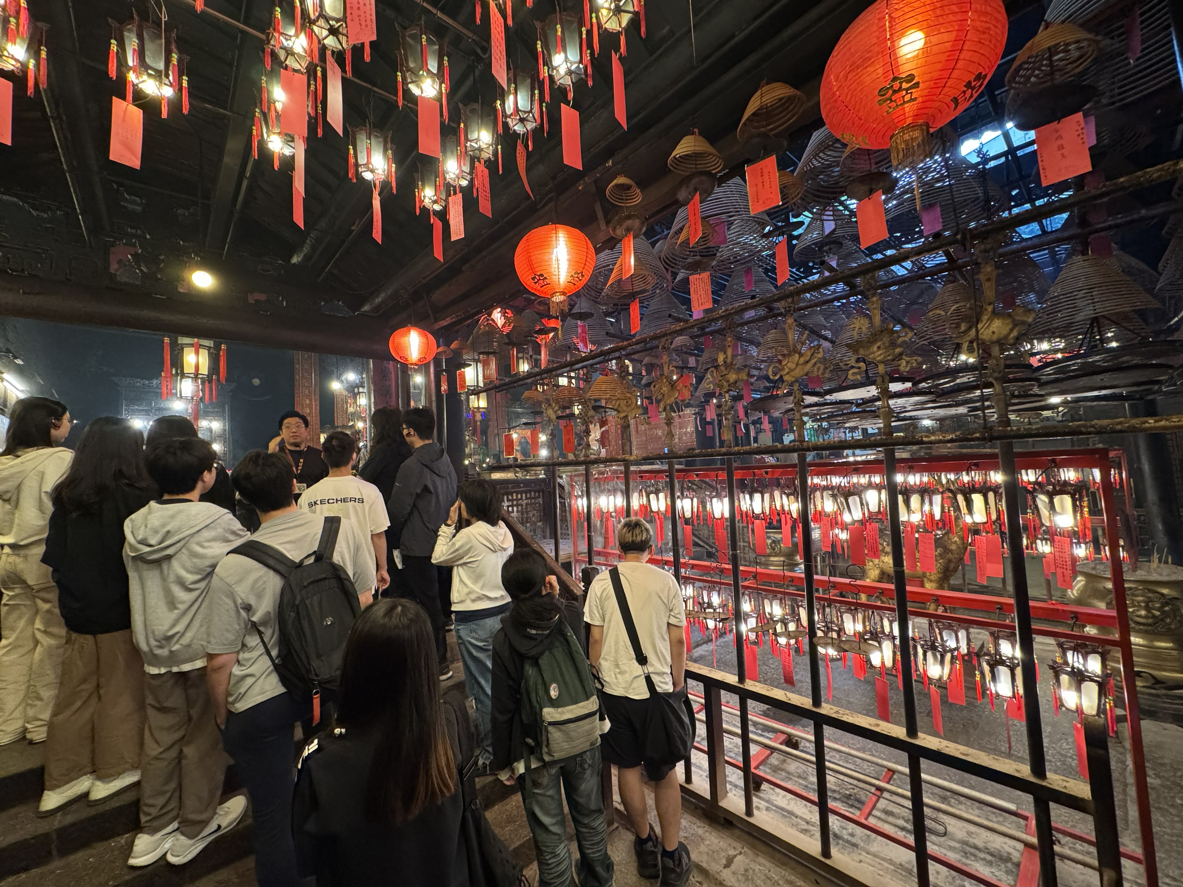 Guide giving a tour and explaining to students on rituals