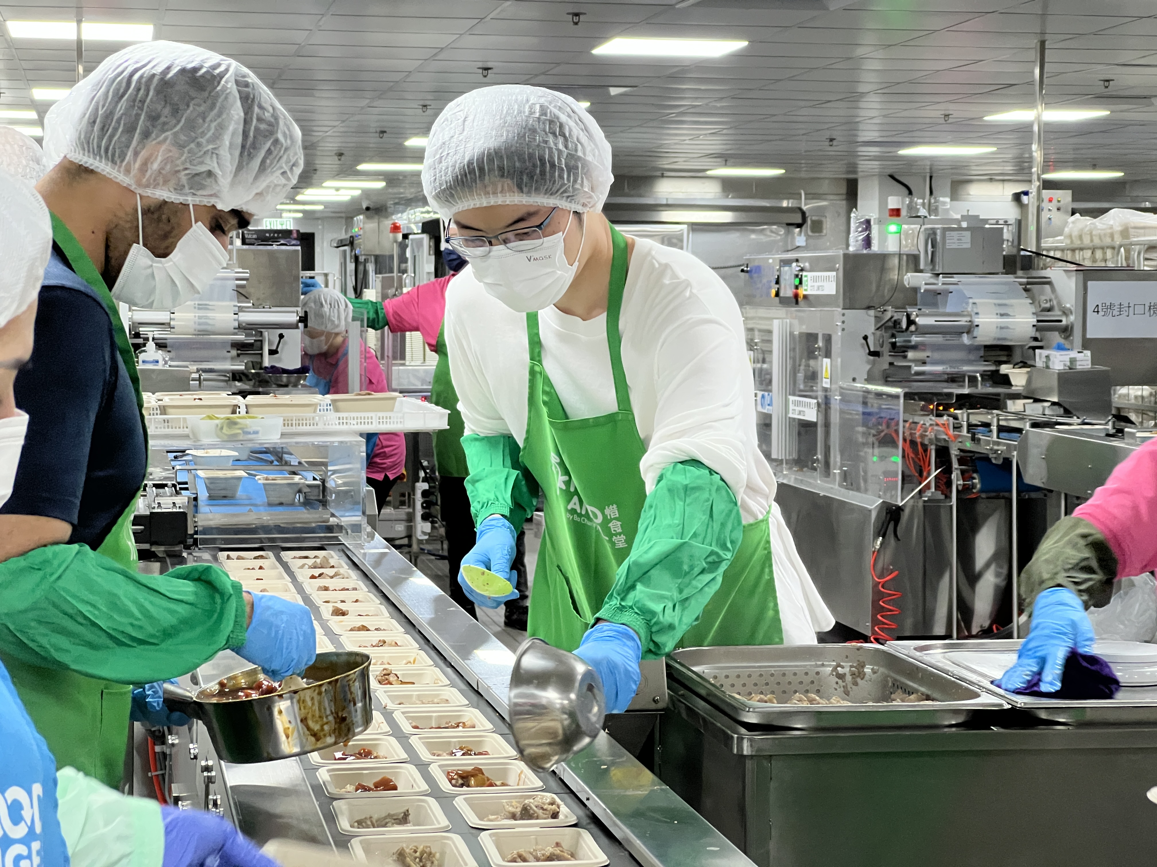 Volunteers working together to prepare meal boxes from high-quality surplus food