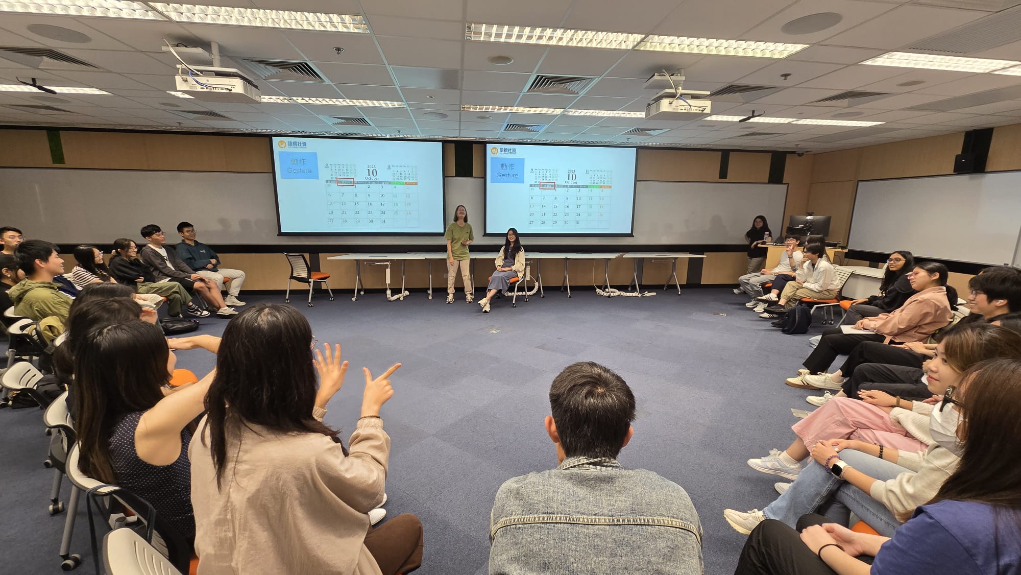 Students learning basic Hong Kong Sign Language from a deaf instructor