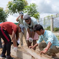 Volunteers constructing the base for solar panels