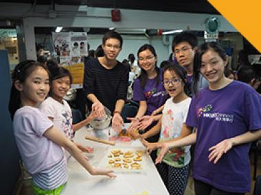 Volunteers having fun cooking with the children.