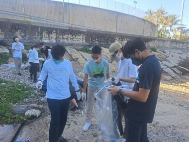 Volunteers picking up trash found on the beach.