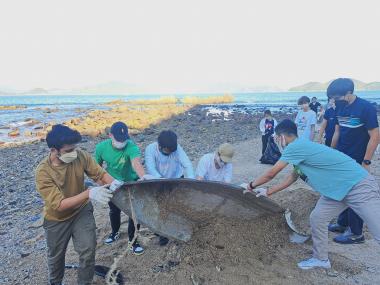 Volunteers removing an abandoned boat found on the beach.