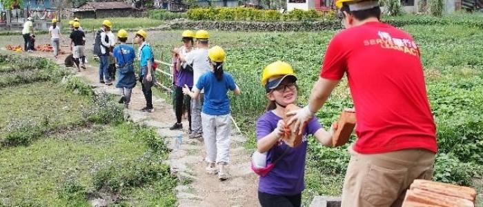 volunteers passing bricks in a line