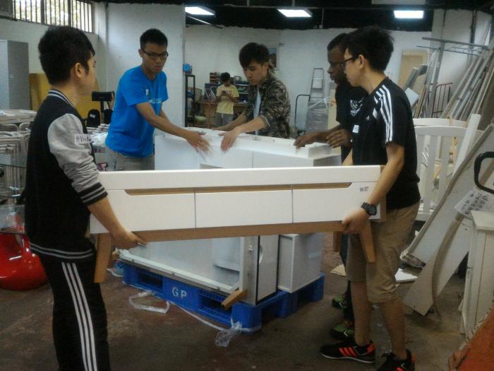 Volunteers packing the furniture for delivery
