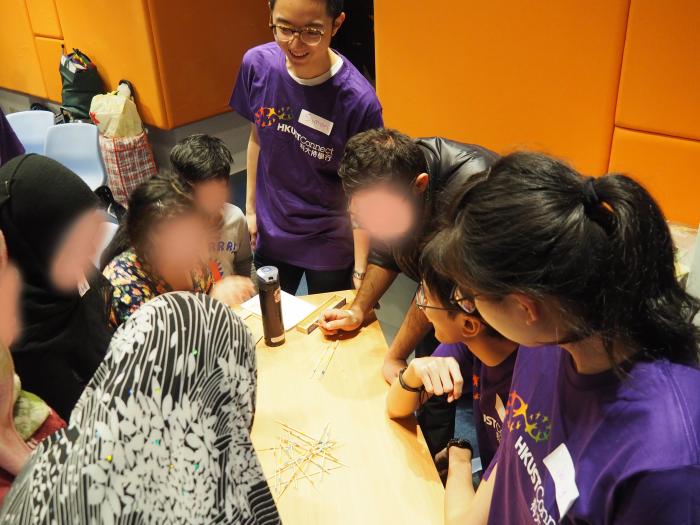 Volunteers introducing a Hong Kong game to recipients