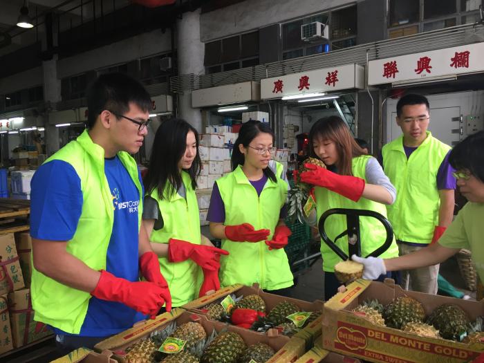 Volunteers checking if the pineapples are good to donate to people in need