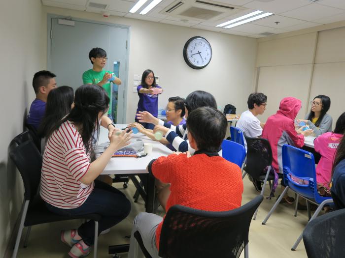 Volunteers teaching the visually impaired people of hand exercise